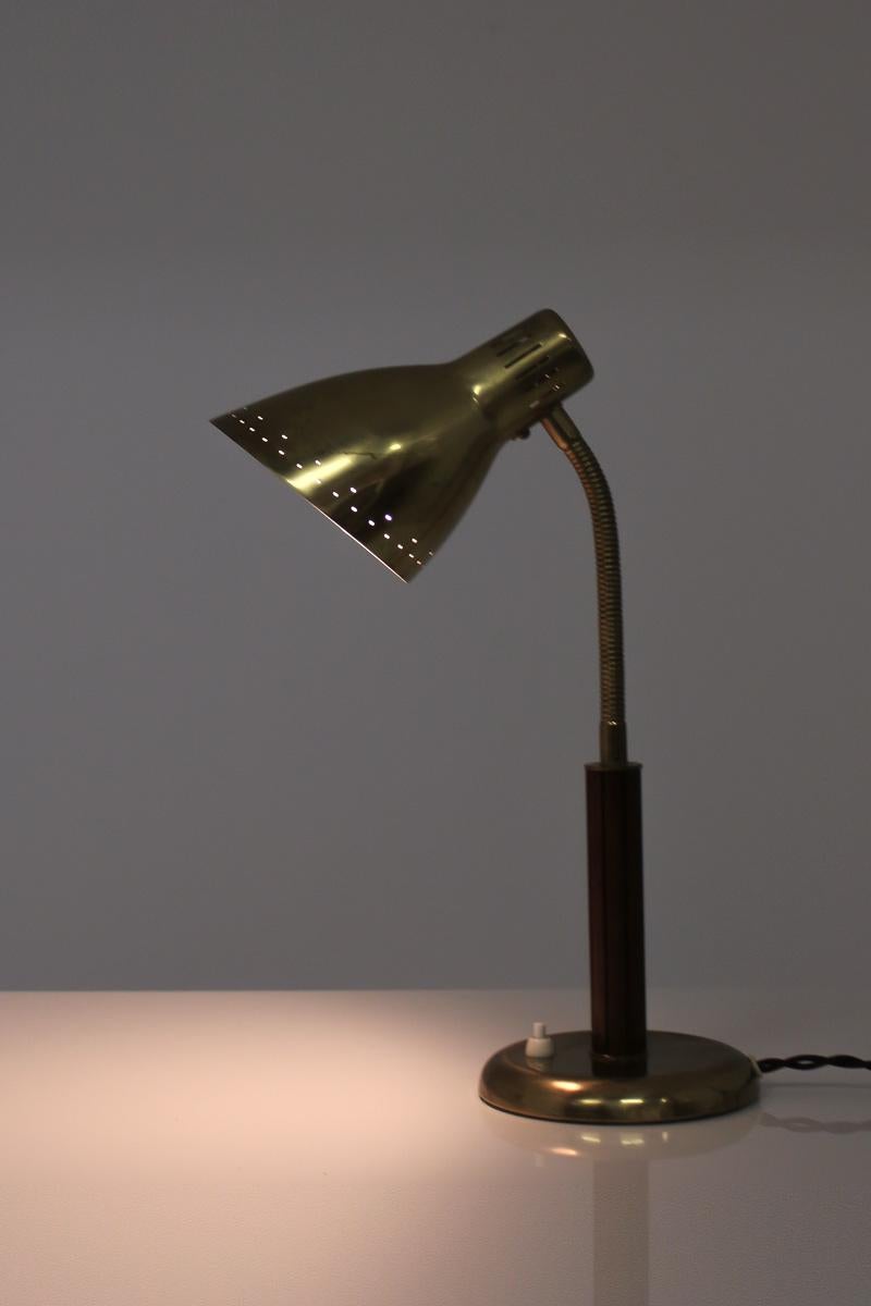 A desk lamp by Swedish manufacturer Arvid Böhlmarks Lampfabrik. The lamp is made of brass and mahogany with a beautifully shaped perforated shade.
Fits an E-27 socket
Condition: Good original condition with beautiful patina.