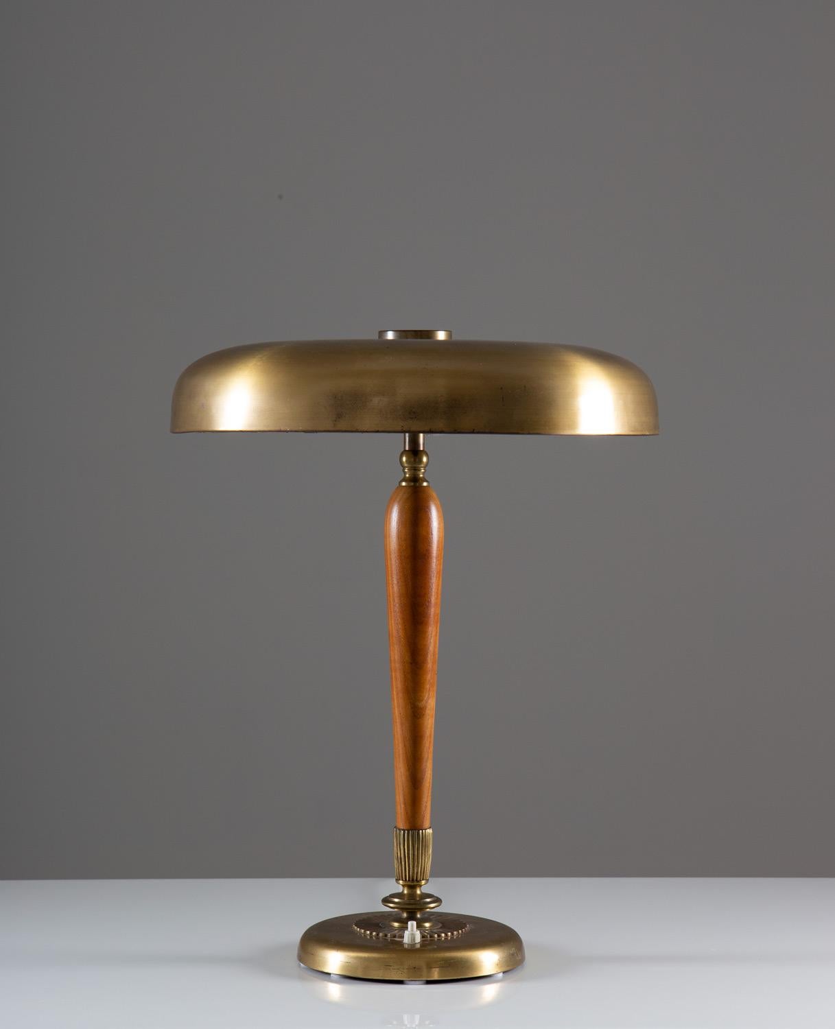 Rare table lamp in brass and wood produced in Sweden, circa 1940.
This elegant lamp was designed during the Swedish Modern era and is made of brass with wooden details. The quality of this lamp is very high and the size is impressive.