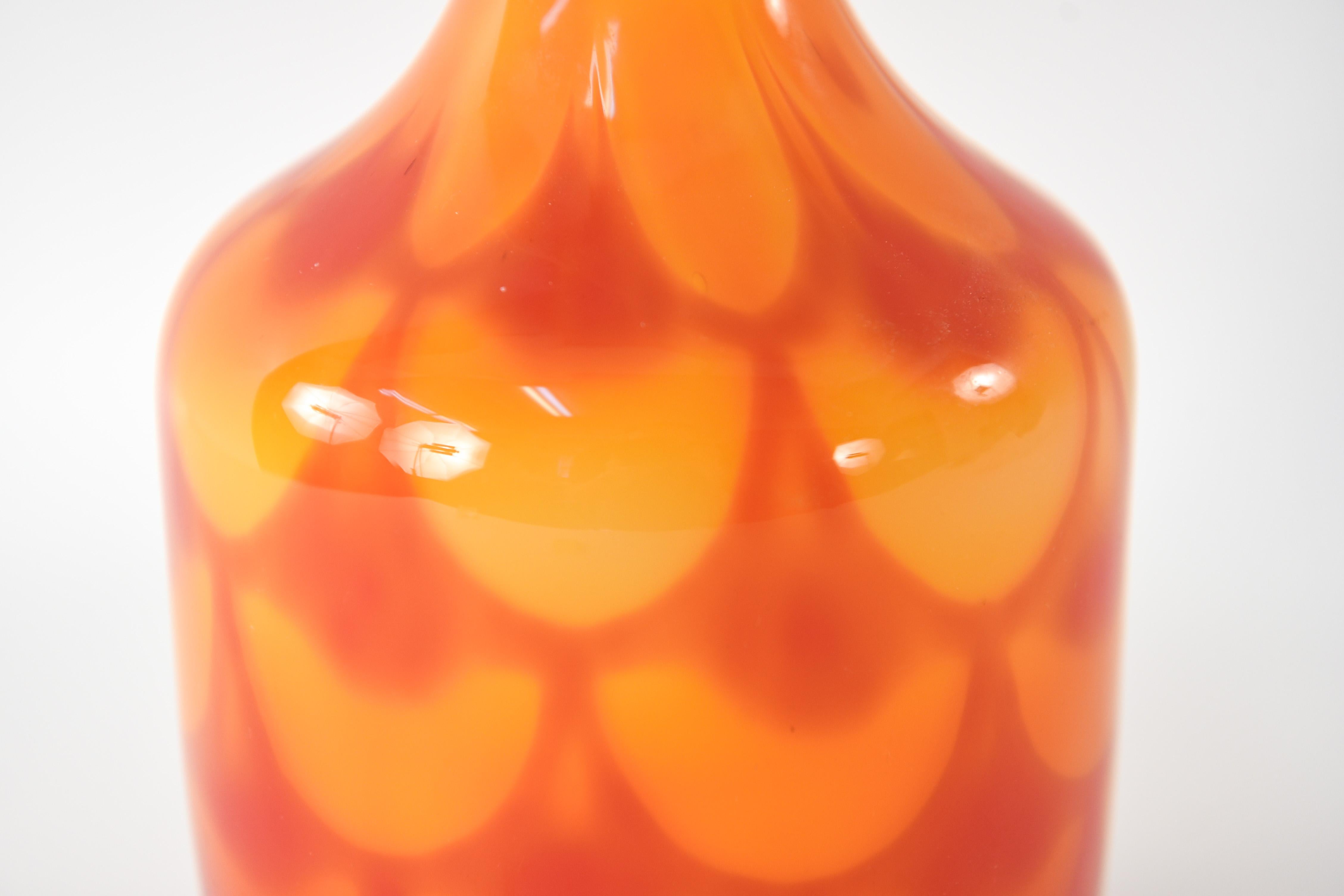 This Swedish midcentury vase is full of warm red and orange hues. This piece would be a lovely place to hold flowers, or can simply act as an accent piece on its own to provide a small pop of bright color to an interior.