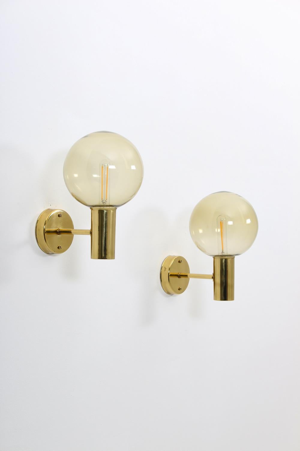 Set of four wall lights by Hans-Agne Jakobsson for AWF (Norway)
Beautiful wall lamps in brass with brown glass shades
Condition: Very good original condition.
 