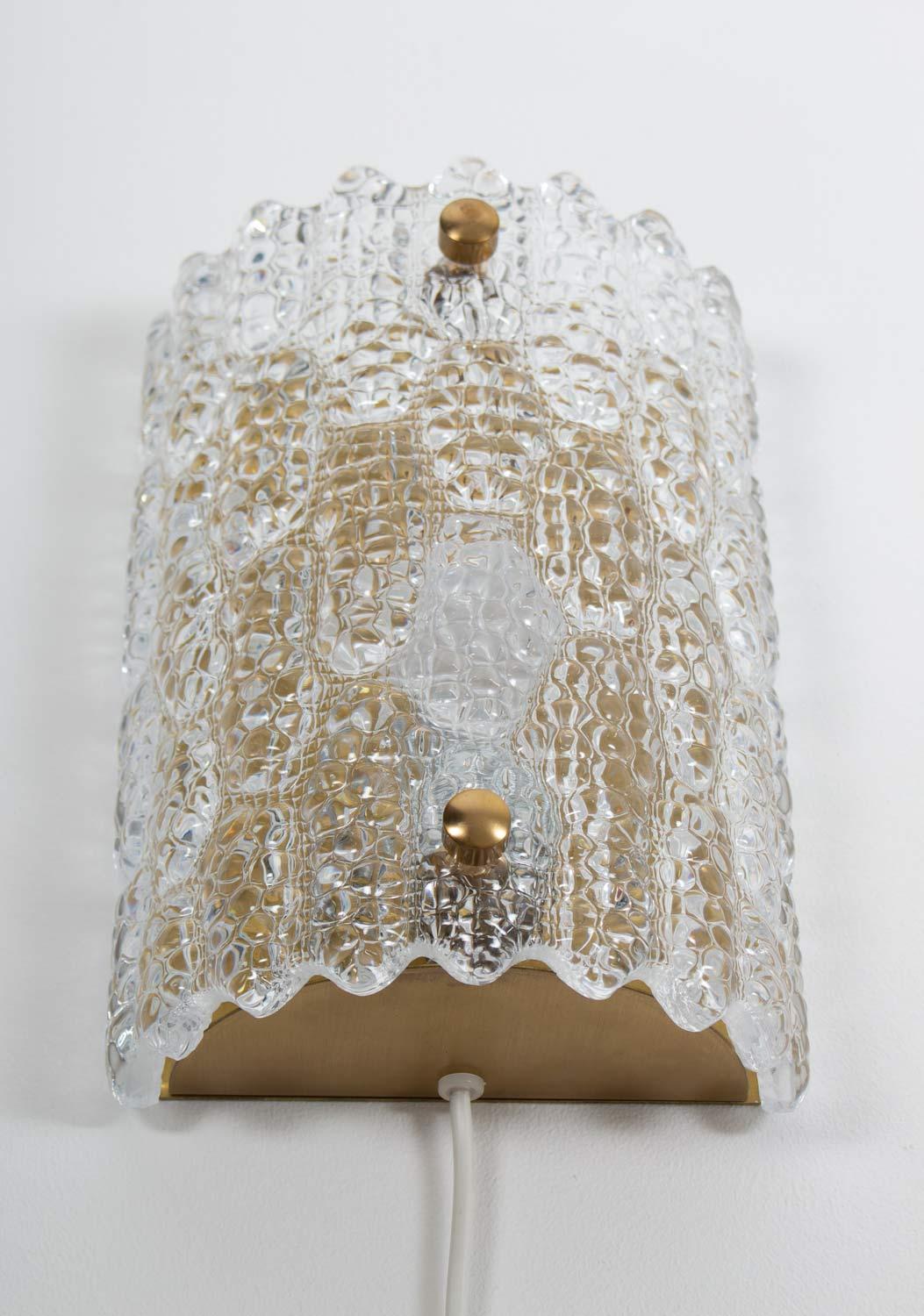 Beautiful wall lamps by Carl Fagerlund for Orrefors, Sweden.
The lamps consist of a crystal glass block fixture on a brass bottom.
5 pieces available.
Condition: Very good original condition.