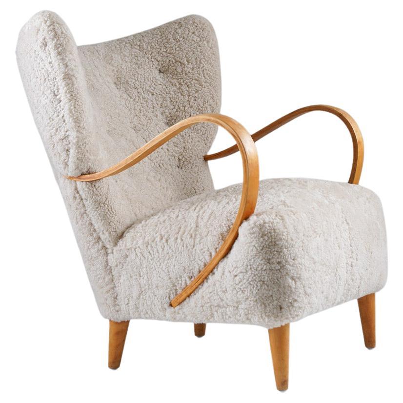 Swedish Midcentury Wingback Lounge Chair in Sheepskin For Sale