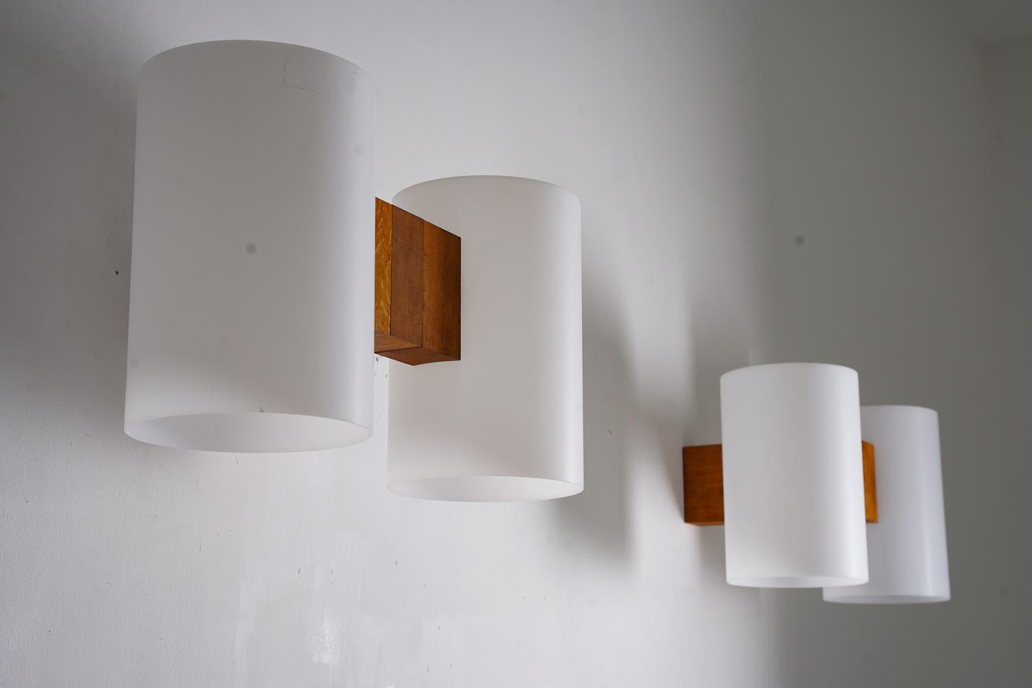 Add a touch of Scandinavian style to your home with these beautiful wall lamps by Uno & Östen Kristianson for Luxus, Sweden.

The lamps are made of oak and feature white plexi shades that diffuse the light beautifully, creating a warm and inviting