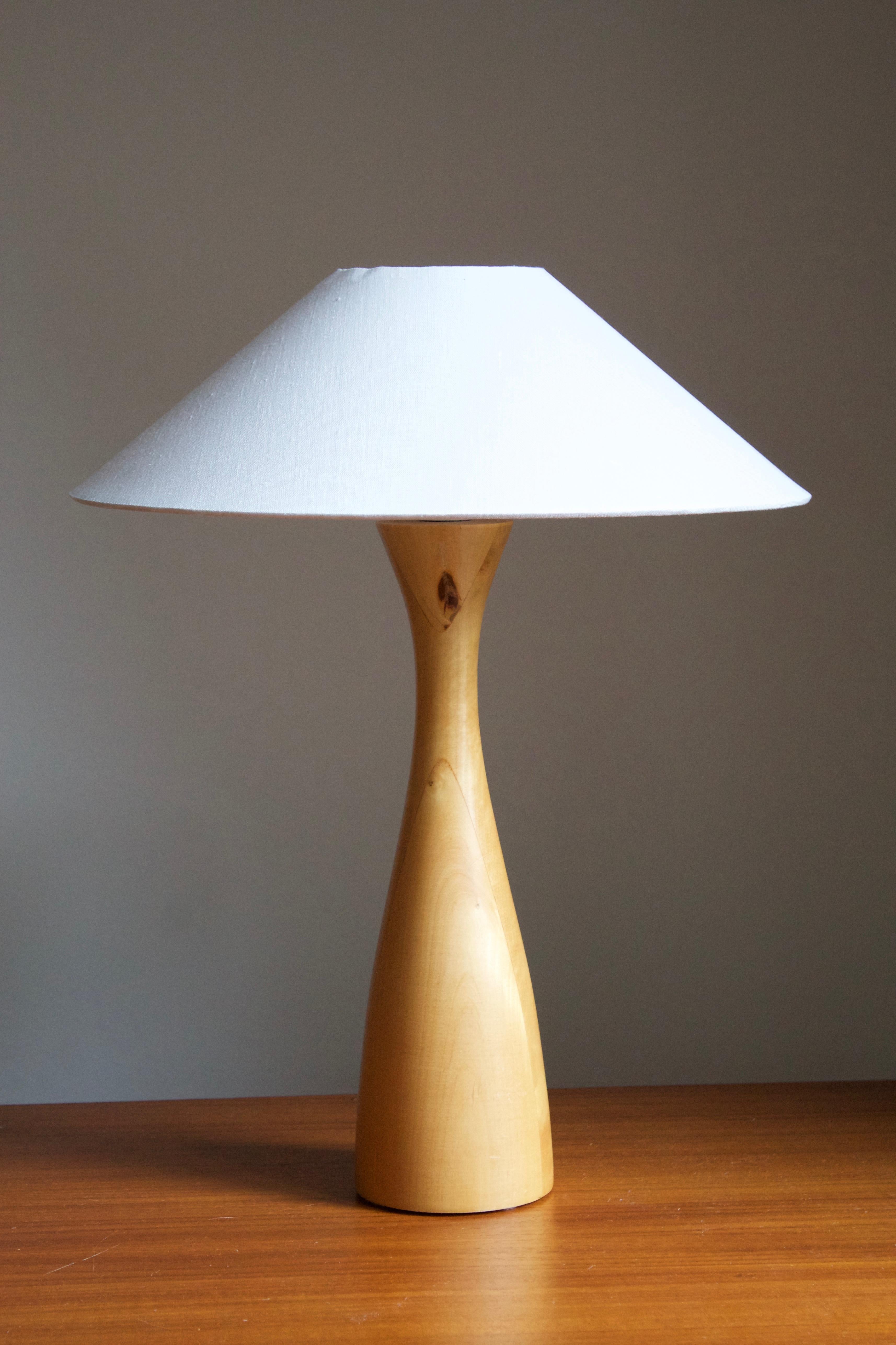 A minimalist table lamp. Designed and produced in Sweden, 1970s. Features turned solid wood.

Stated dimensions exclude lampshade. Height includes socket. Sold without lampshade.