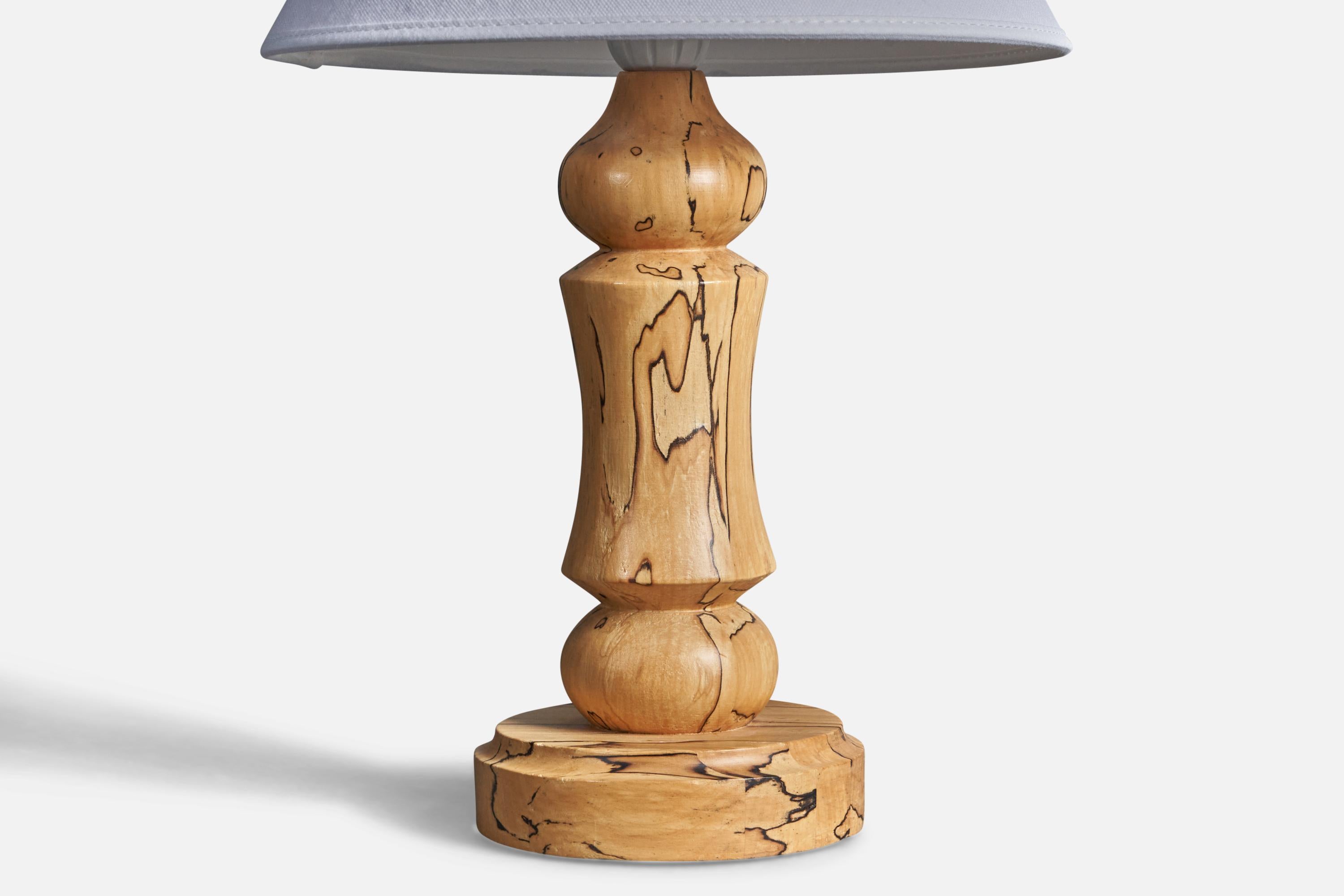 A Swedish craft table lamp. In turned solid Masur birch, Sweden, 1970s.

Condition: Good

Wear is consistent with age and use.

Dimensions of Lamp (inches): 11.75” H x 4.75” Diameter

Dimensions of Shade (inches): 4.5” Top Diameter x 10” Bottom