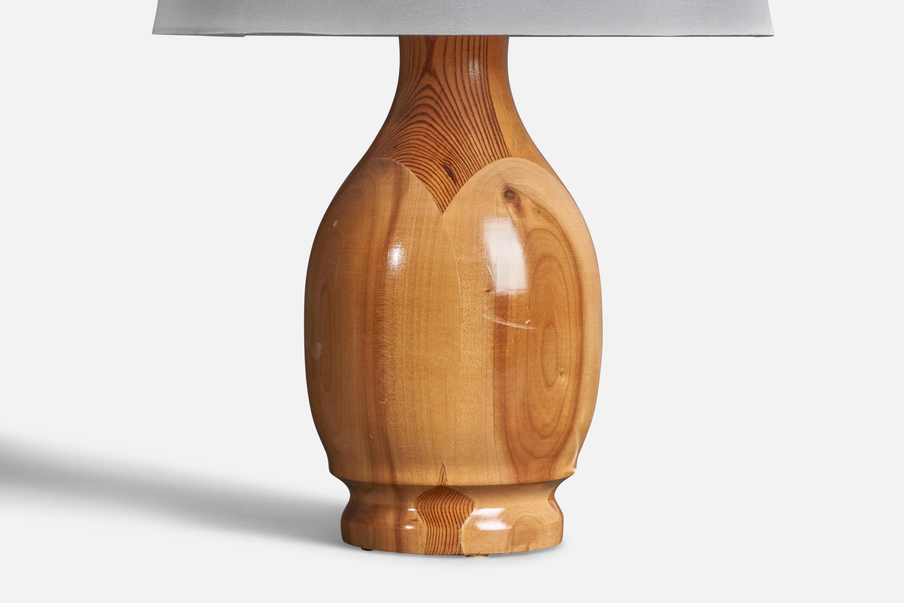 A table lamp designed and produced in Sweden, dated 1989. In solid pine.

Condition: Good 
Wear consistent with age and use.

Dimensions of Lamp (inches): 15” H x 6” Diameter

Dimensions of Shade (inches): 9” Top Diameter x 12” Bottom Diameter x 9”