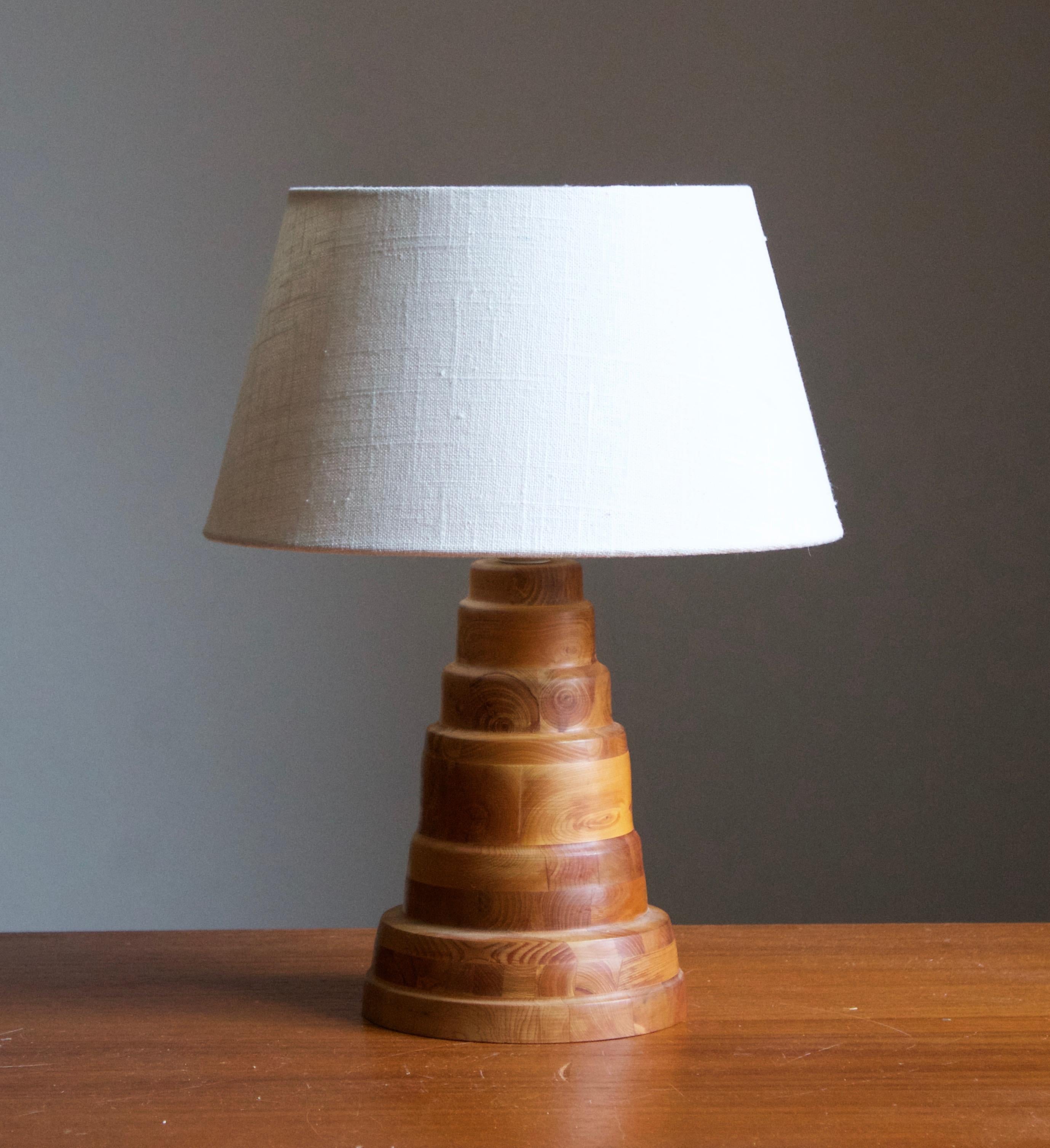 A pine table lamp, designed and produced in Sweden, Initialed and dated 1985.

Stated dimensions exclude lampshade. Height includes socket. Sold without lampshades.