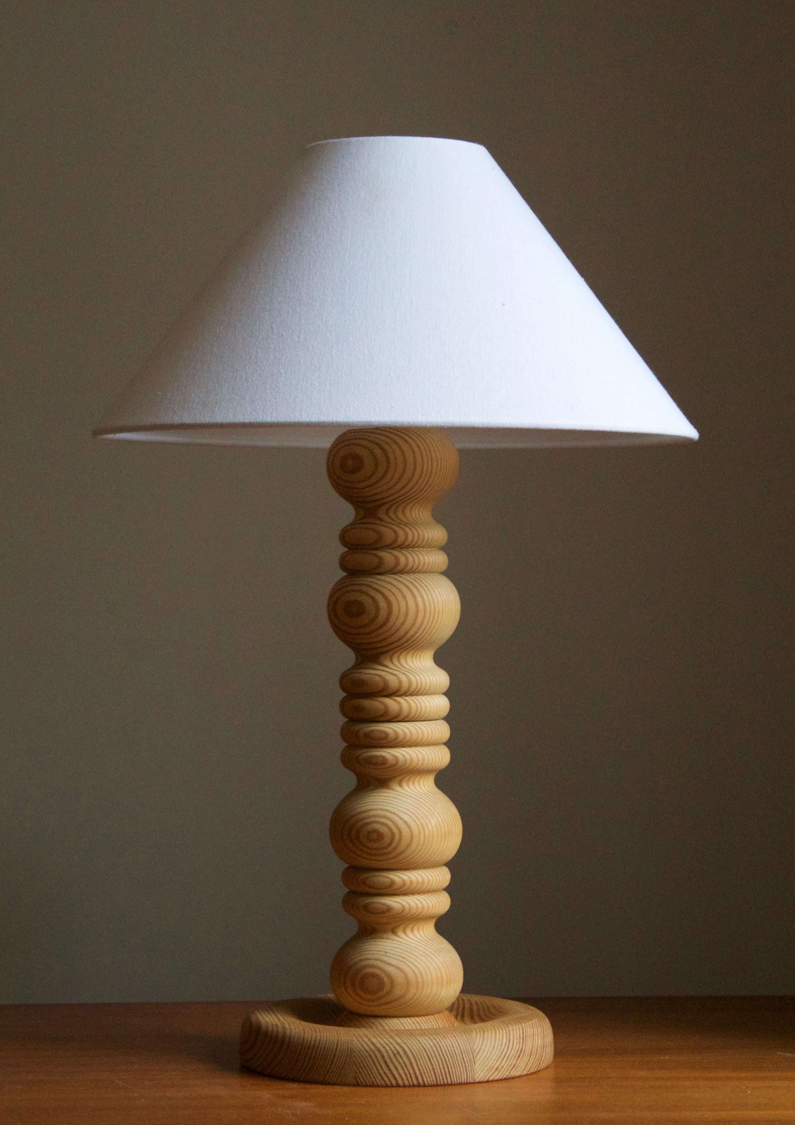 A sizable solid pine table lamp, designed and produced in Sweden, c. 1970s. 

Stated dimensions exclude lampshade. Height includes socket. Sold without lampshade.