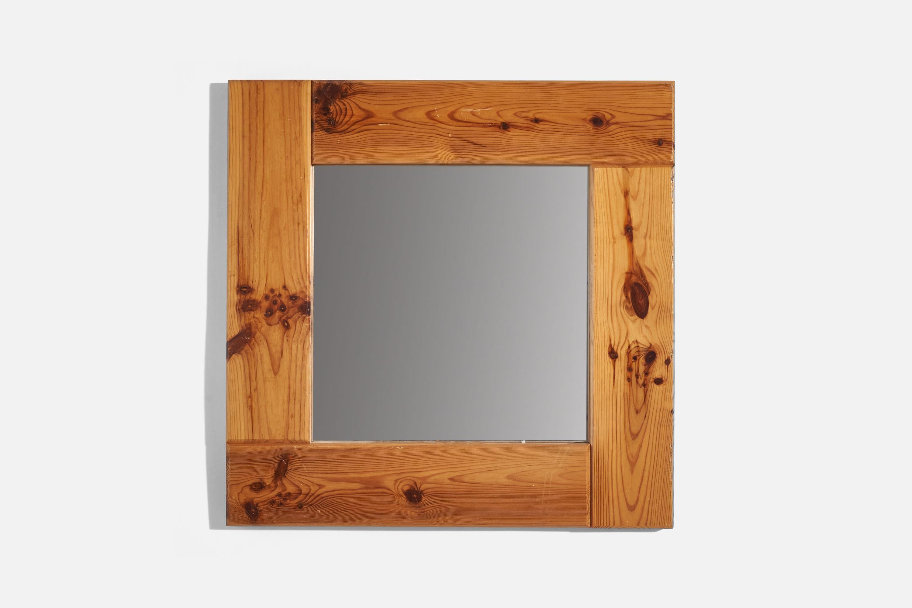 A solid pine wall mirror designed and produced in Sweden, 1970s. 


