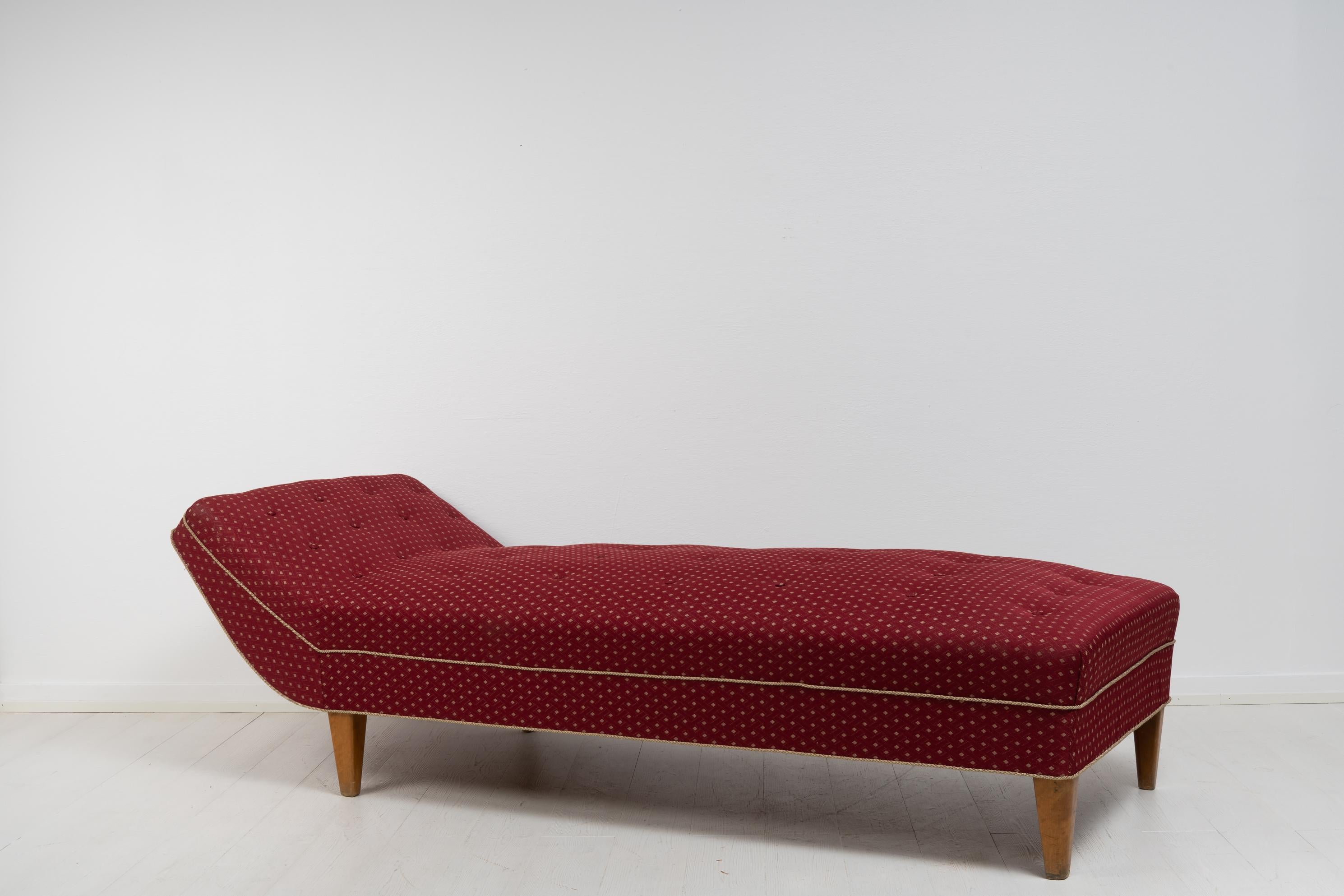 Scandinavian modern Swedish daybed from around the 1930s. The daybed has legs in birch and the original patterned upholstery. Good vintage condition consistent with age and use. The daybed dates back hundreds of years and is a versatile furniture