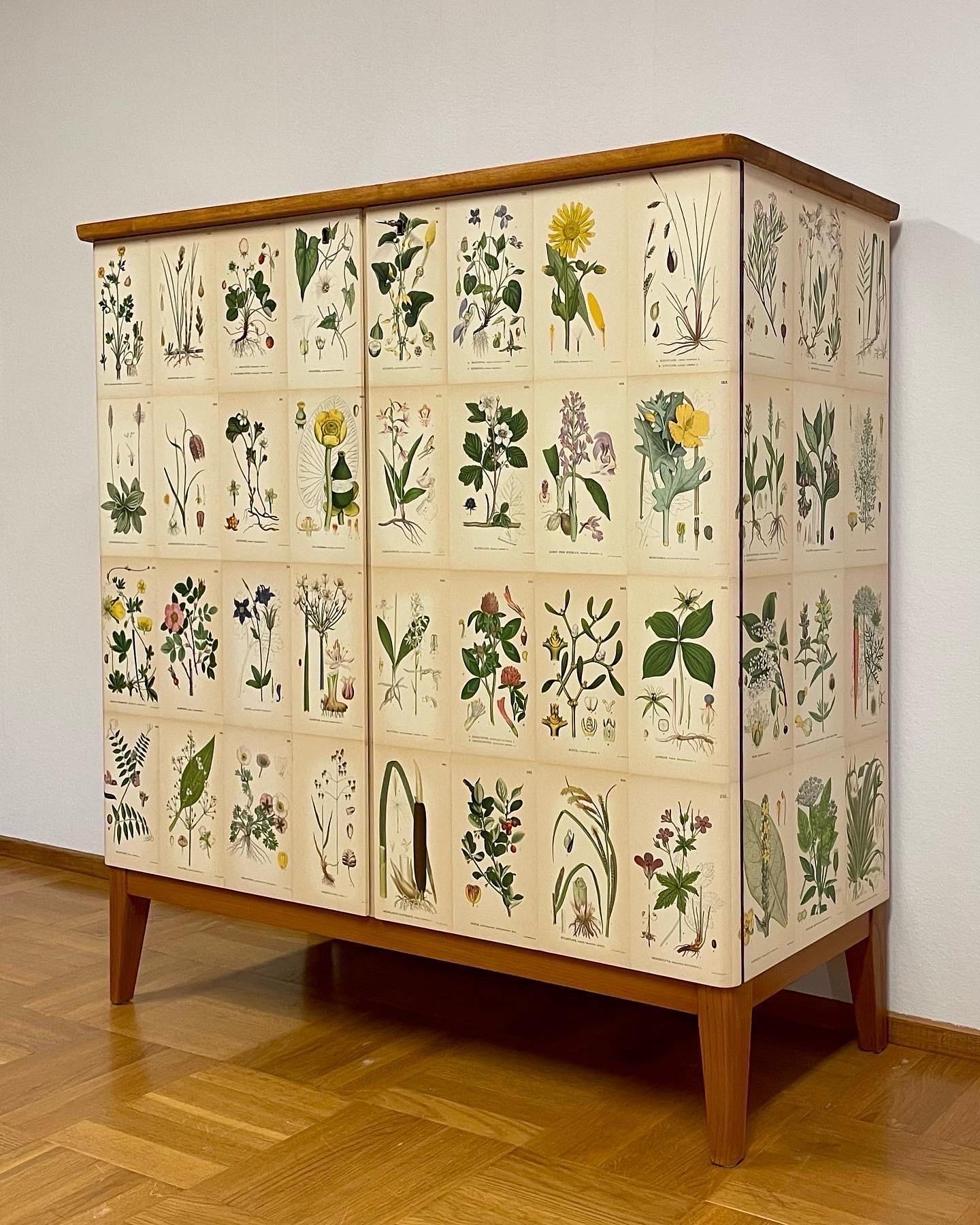 This is the Swedish Modern 1940s cabinet in Josef Frank-style. 

This cabinet is made of birch and comes with a top veneered in birch. 
Elegant cabinet in Josef Frank-style, manufactured in the 1950s. 
Later covered with pages from the antique