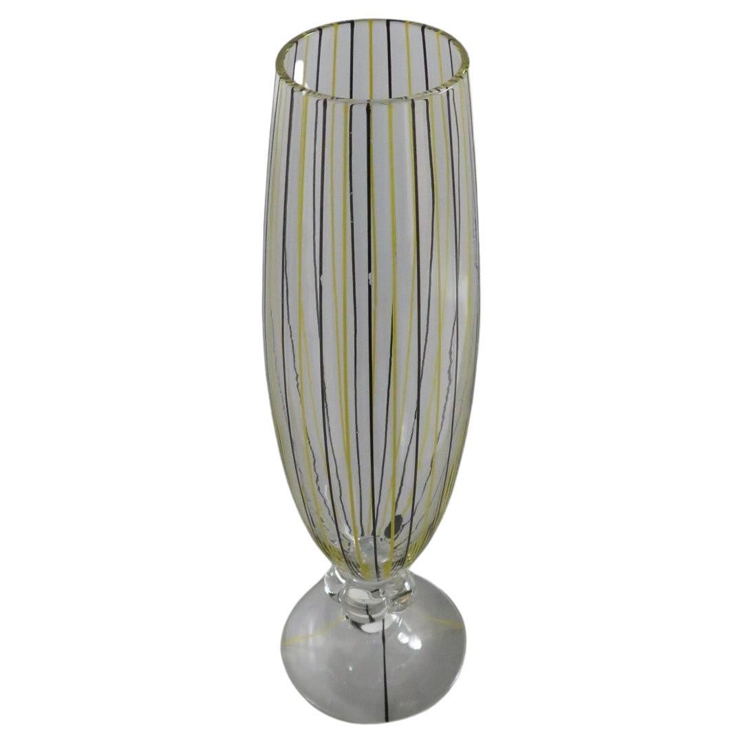 Lovely Swedish blown glass stemmed Vase by AFORS from the 1940s. Hand decorated with perpendicular stripes in alternating black and yellow on the slender fluted body separated from the inverted saucer base by a clear flower shaped stem. One