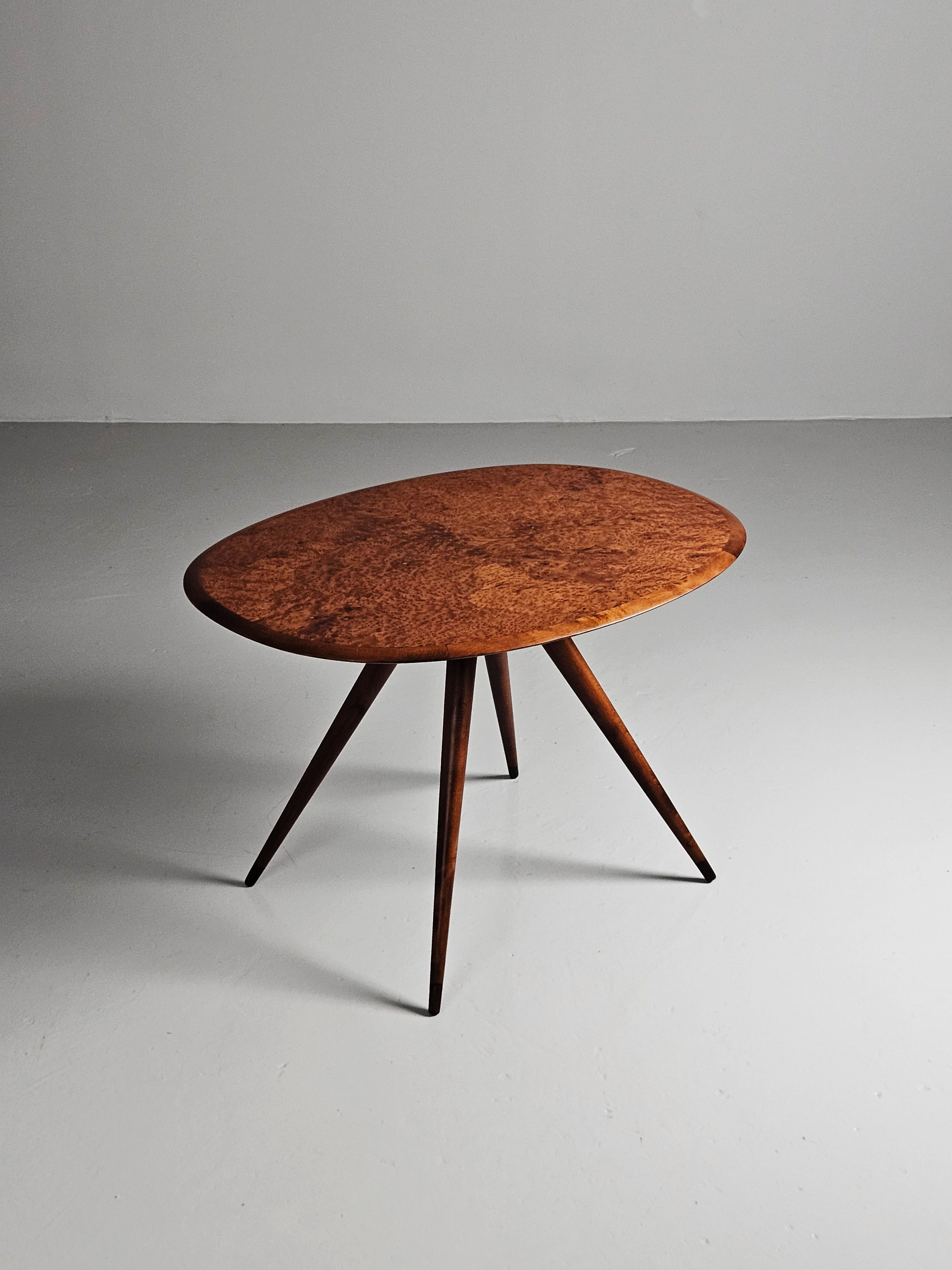 Coffee table in the style of the Swedish designer David Rosén. Modern legs with a classic elm root inlay on the top. 

This table have been gently restored to a very good condition. 