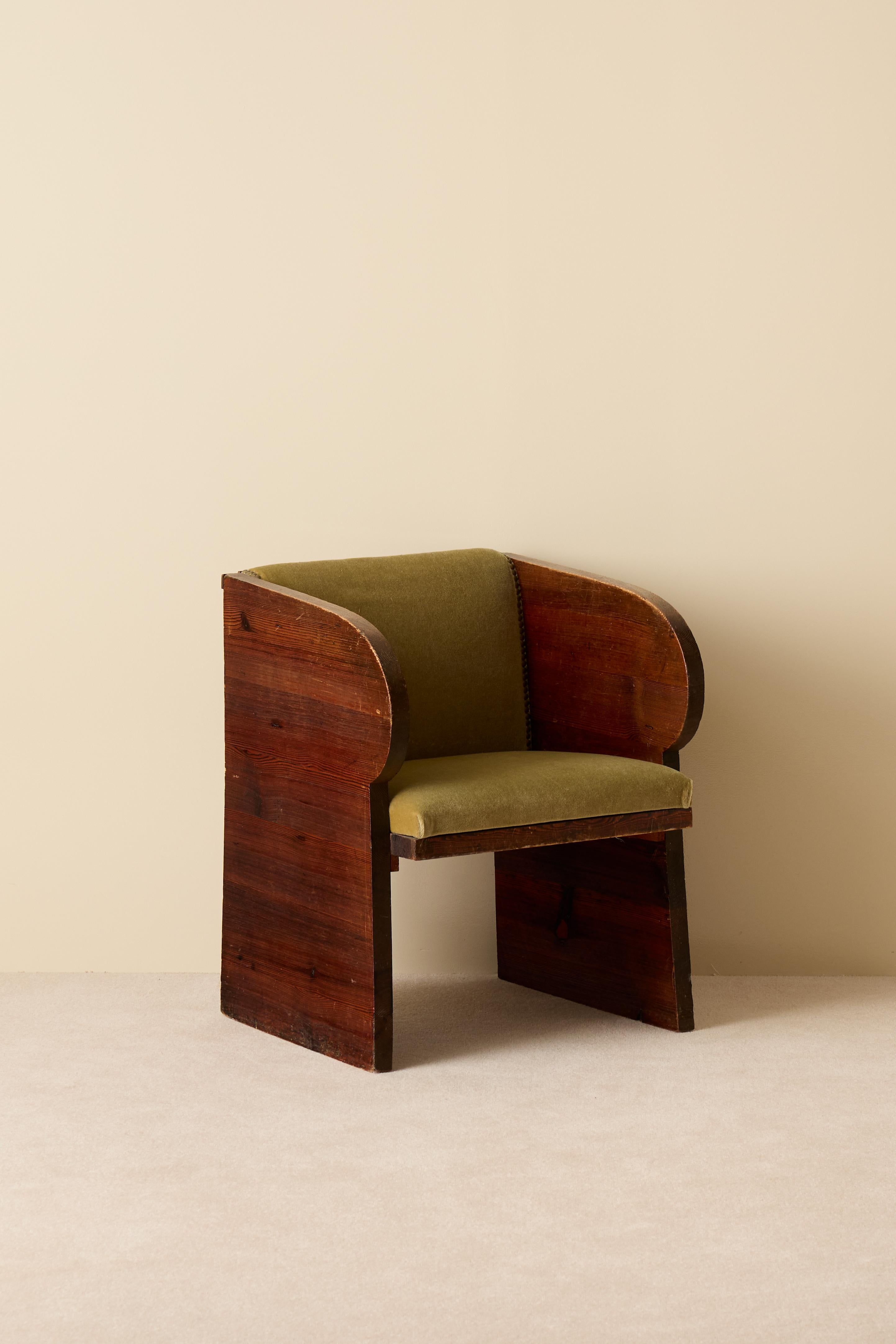 Rare pair of early 1930s Swedish pine armchairs.
These chairs combine sculptural presence with refined materials — solid pine frames with rich grain and original olive-green velvet upholstery. Their bold, geometric silhouette with softly rounded