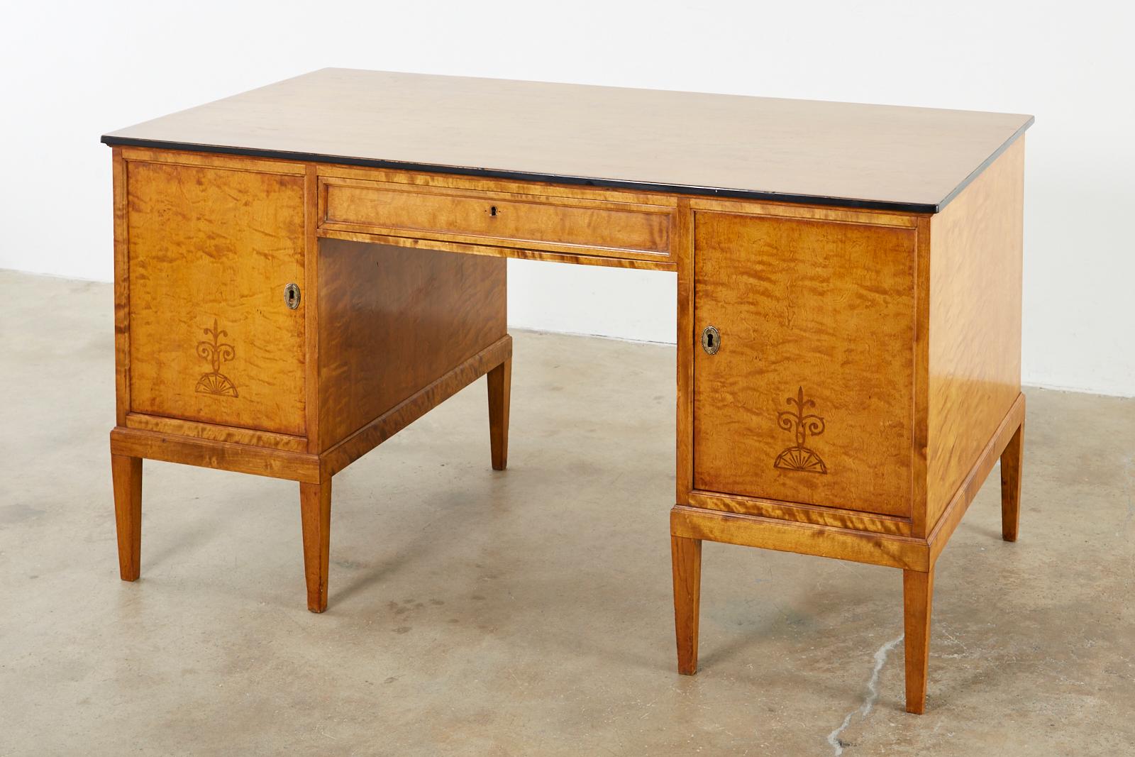 Exquisite Swedish modern writing table or desk produced in the late Art Deco period by SMF Svenska Mobelfabriken Bodafors. Crafted from fantastic, radiant grained flame birch beautifully finished on all sides. Pedestal style desk fronted by two