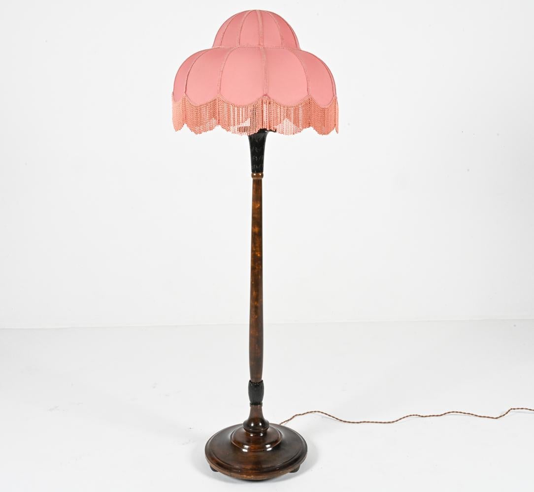 Introduce a touch of whimsical charm to your living space with this captivating Swedish modern floor lamp, crafted circa 1930. This unique piece embodies the essence of the era, blending elegance, functionality, and a touch of the fantastical.

The