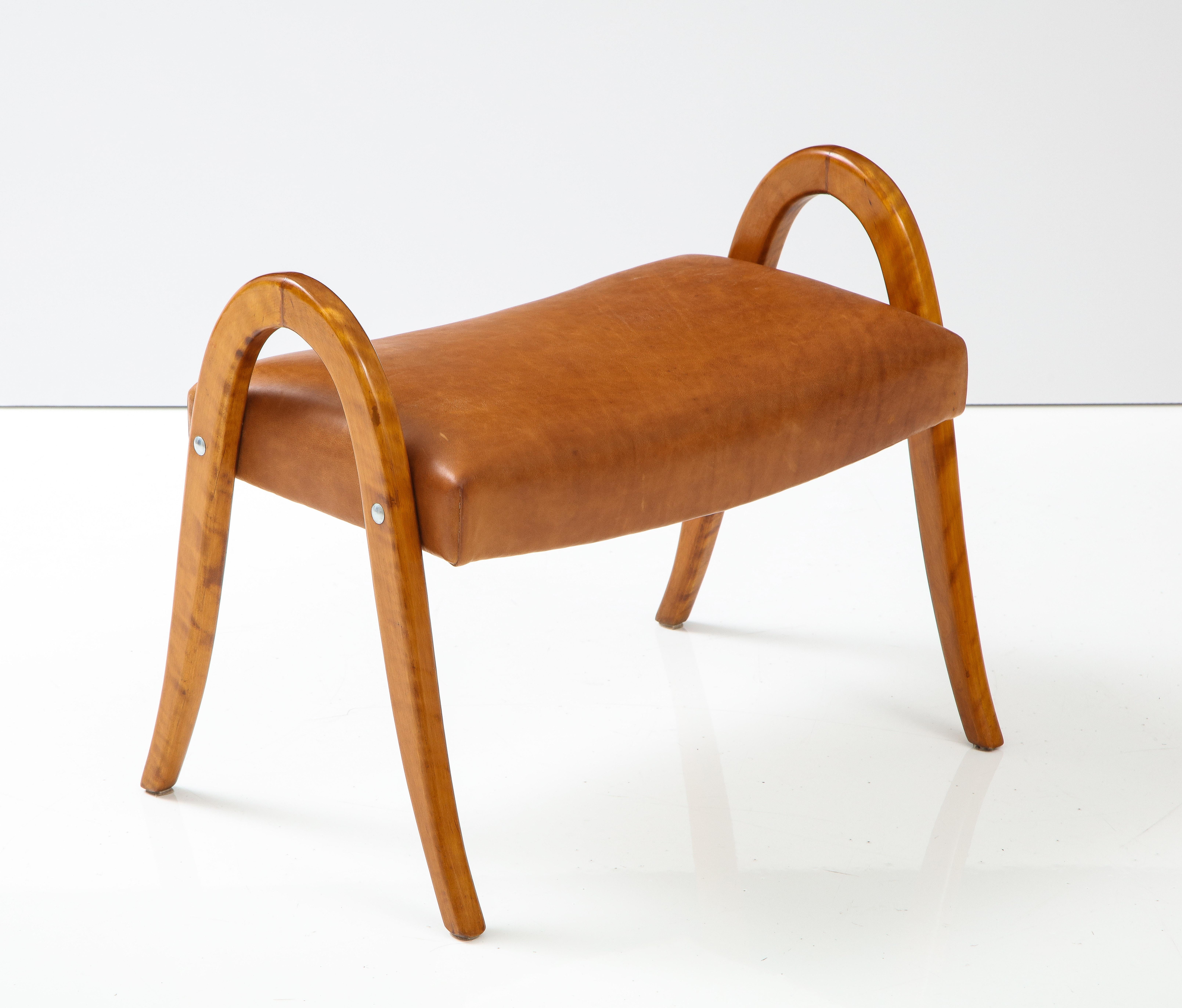 A Swedish Modernist stool, Ca. 1950s, with birch continuous curved supports and a leather upholstered seat.

