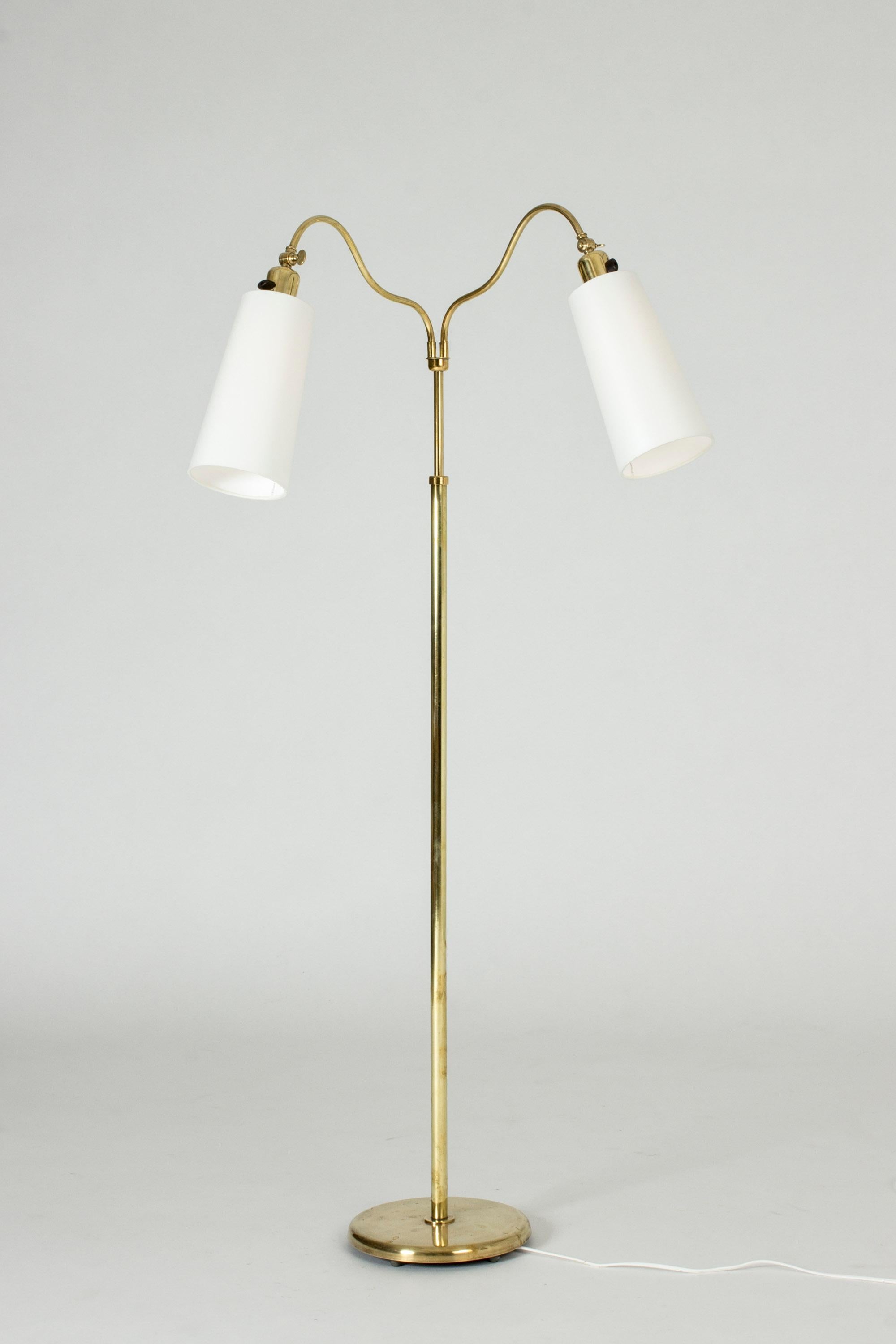 Swedish modern floor lamp, made from brass. Slender, elegant design with billowing necks that extend to the cylinder shaped shades. The height is adjustable and the necks can be swung around. The angles of the shades are adjustable.