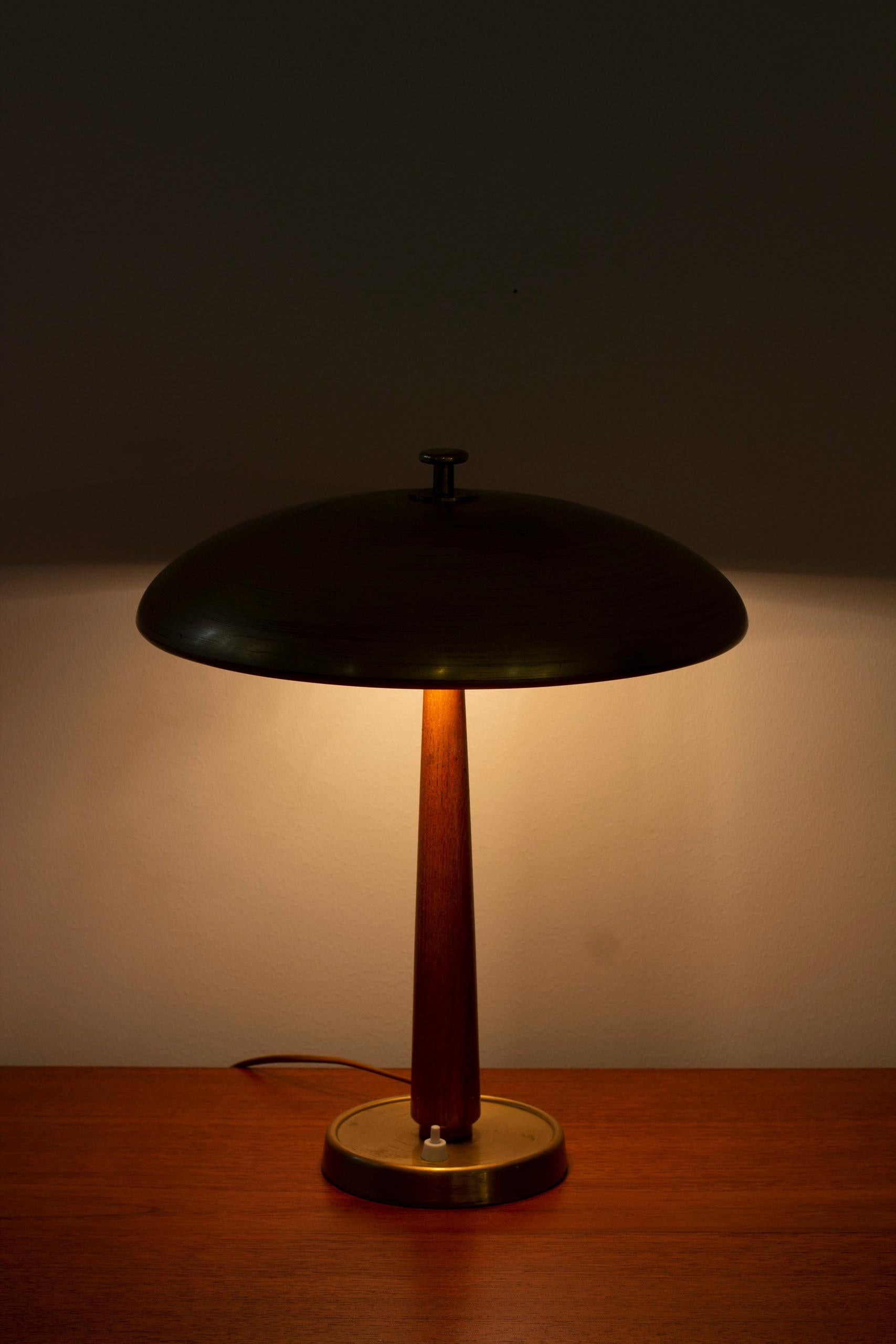 Table lamp model 30331 designed by Bertil Brisborg. Produced in Sweden by Nordiska Kompaniet during the 1940-50s. Made from matte finished brass with solid elm stem. Light switch on the base in working order. Very good vintage condition with age