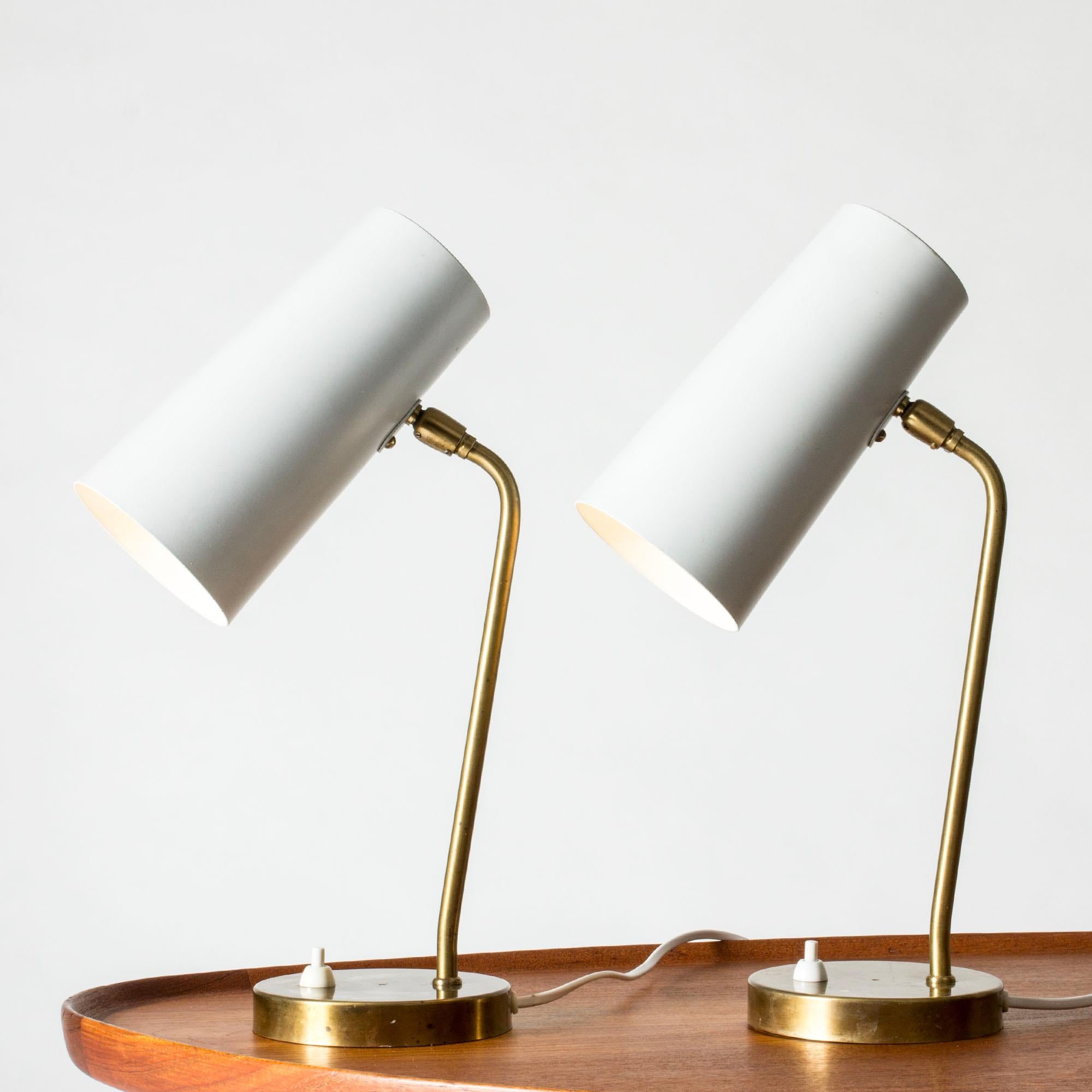 Pair of cool, sleek table lamps from Böhlmarks, made from brass with grey lacquered shades. Cylinder shaped shades that have wide holes at the top, letting out light elegantly.