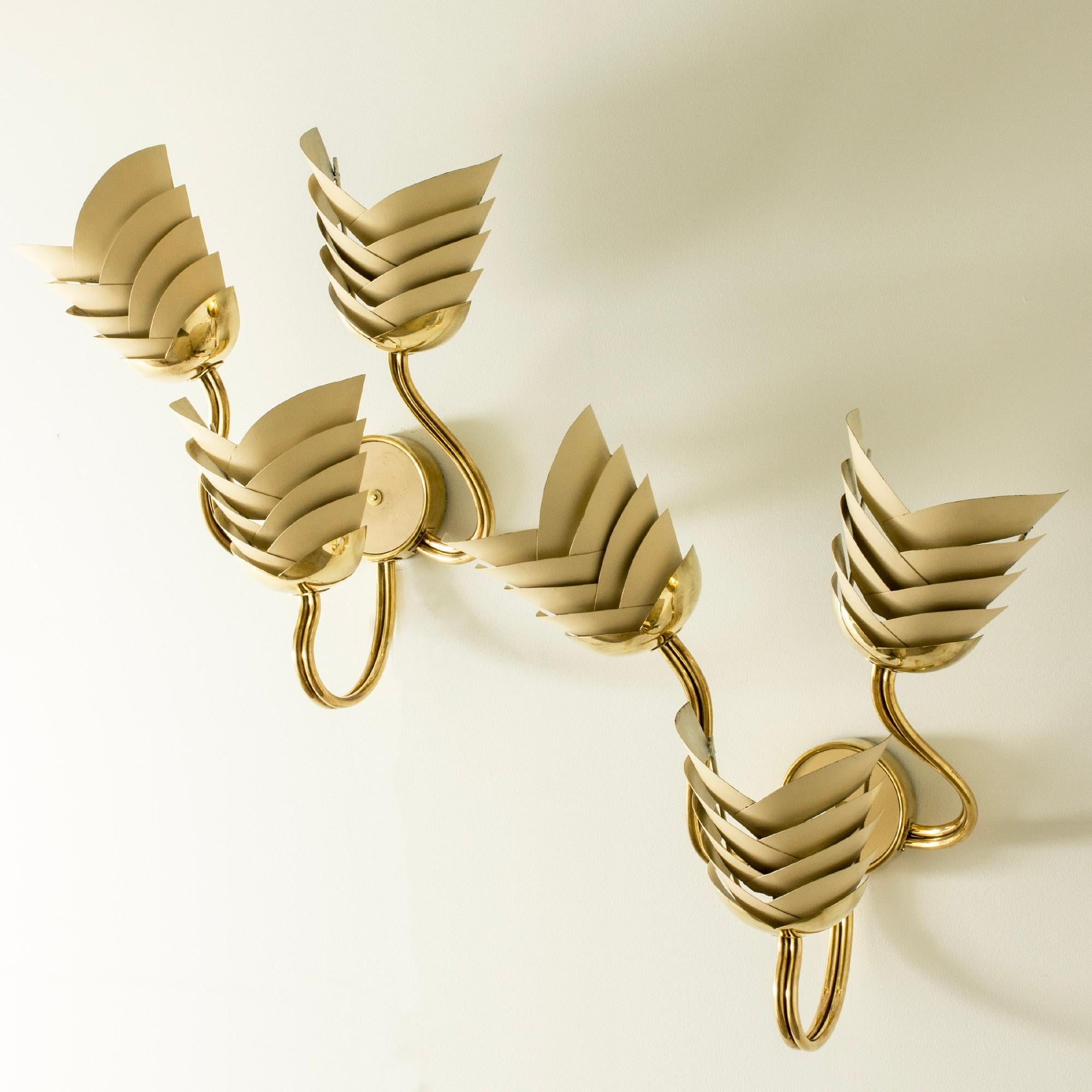 Pair of amazing wall lights from the Swedish Modern period, in a large, striking design. Made from brass with three sconces on each fixture, made with lamellas in an overlapping pattern. Sconces lacquered eggshell white. Emit warm light that