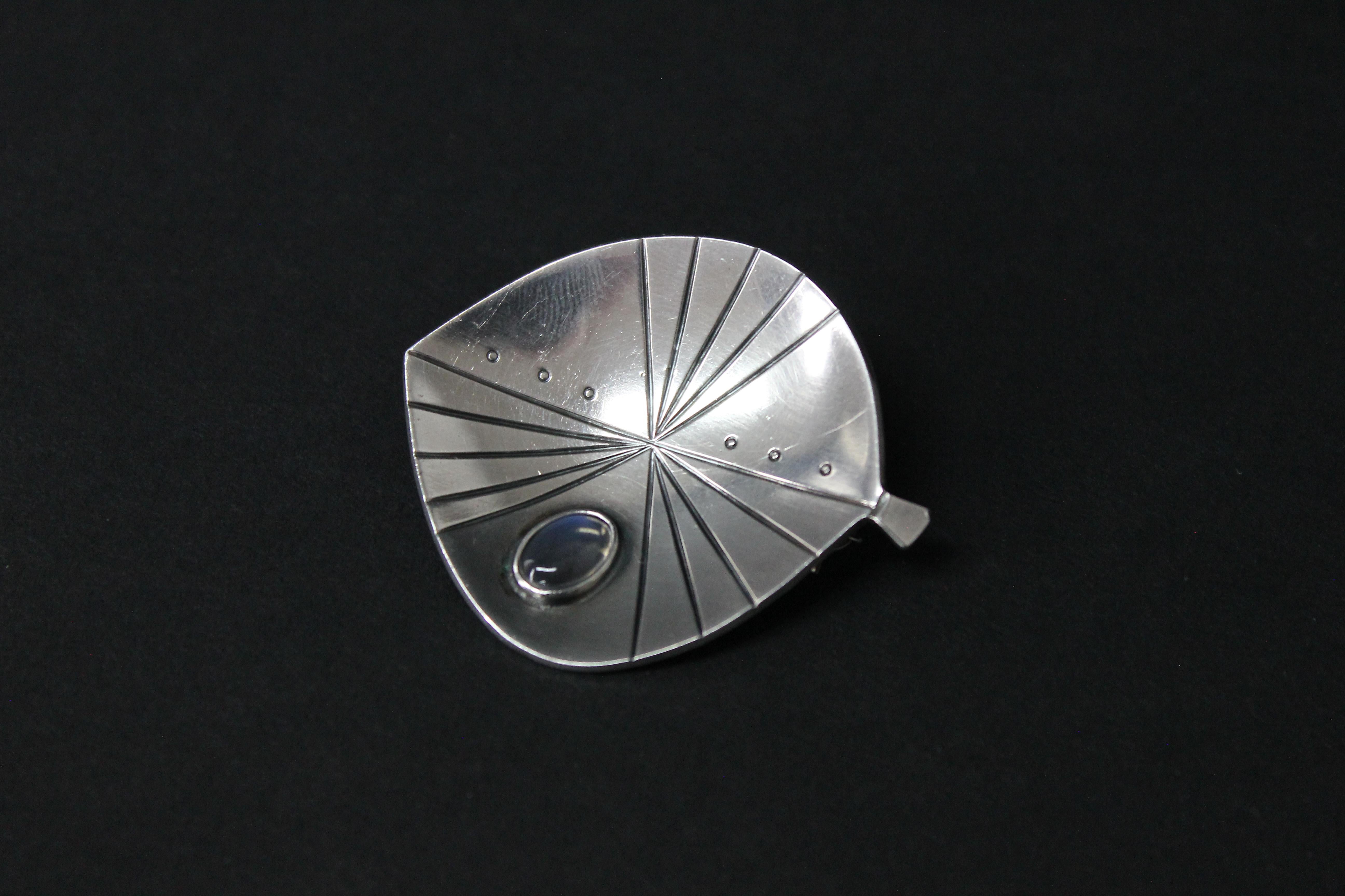 Swedish Modern Brooch by Stigbert for Heribert Engelbert, Stockholm 1957.
Set with a cabochon cut moonstone. 
Good condition. Size, 4.5 x 4cm.