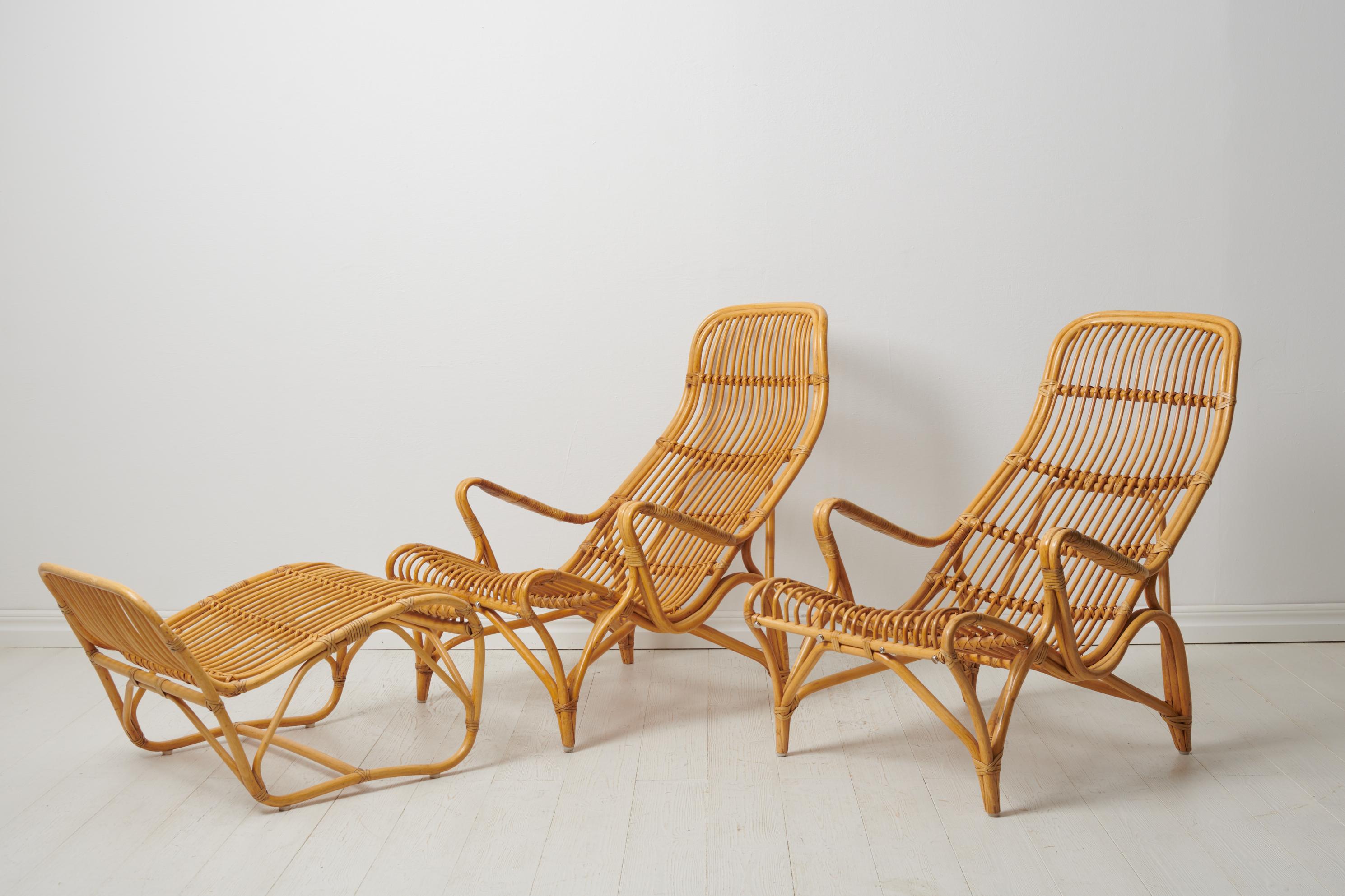 Lounge chairs by Bruno Mathsson in rattan. Indulge in luxury with this pair of iconic lounge chairs by Bruno Mathsson, a rare pair in rattan accompanied by a footstool for DUX. This model, with its distinctiveness, was only produced in limited