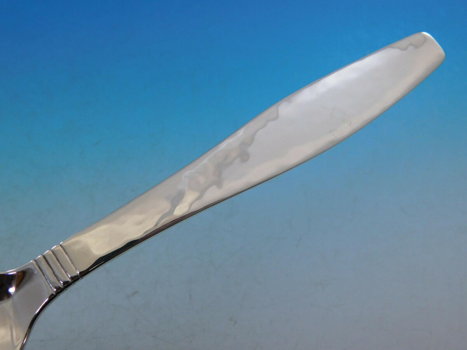 Swedish Modern by Allan Adler handwrought sterling silver Flatware set with heavily hand-hammered finish, 73 pieces. This set includes:

8 dinner knives, solid handles, 8 5/8