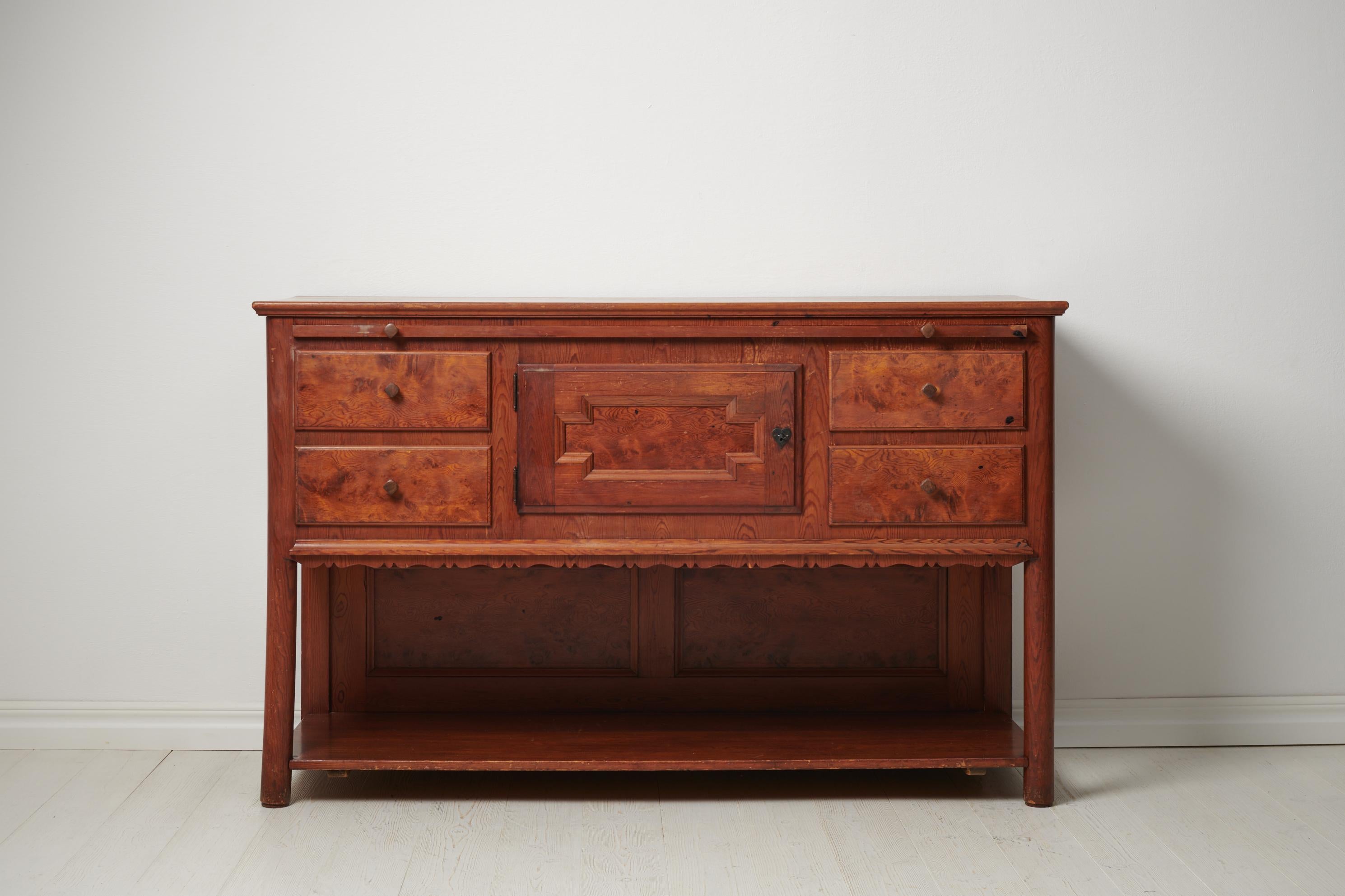 Swedish modern serving sideboard made by Erik Alström Handels Fabriks AB around 1920. The sideboard is made in solid pine and has an acid stained front to the drawers and door. It also has an extendable table top to be used for serving, see