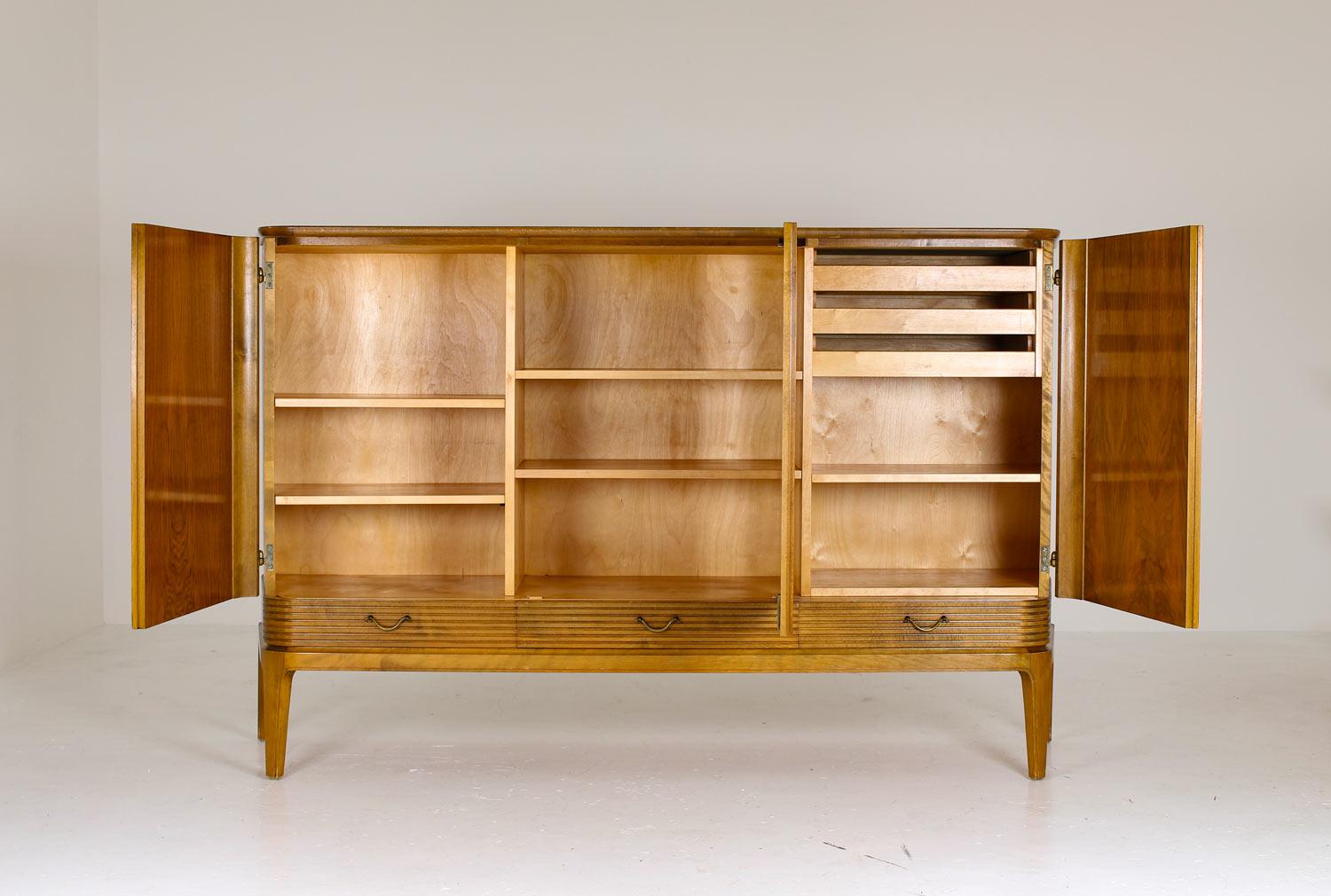 A rare cabinet in the manner of Axel Larsson, probably produced by Bodafors, Sweden.
This majestic piece is a great example of the high-quality and well-designed furniture that was produced in Sweden at the time. The cabinet consists of three large