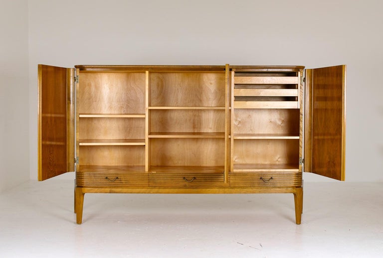 A rare cabinet in the manner of Axel Larsson, probably produced by Bodafors, Sweden.
This majestic piece is a great example of the high-quality and well designed furniture that was produced in Sweden at the time. The cabinet consists of three large
