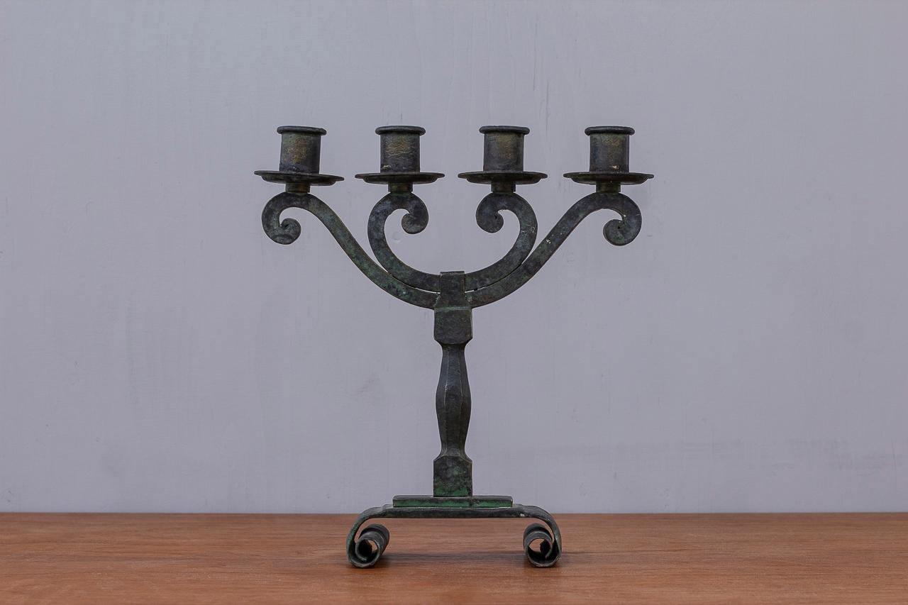 Swedish Modern candelabra in patinated bronze. 
Manufactured in Sweden during the 1940s. 
The candelabra was made in the period in between the 