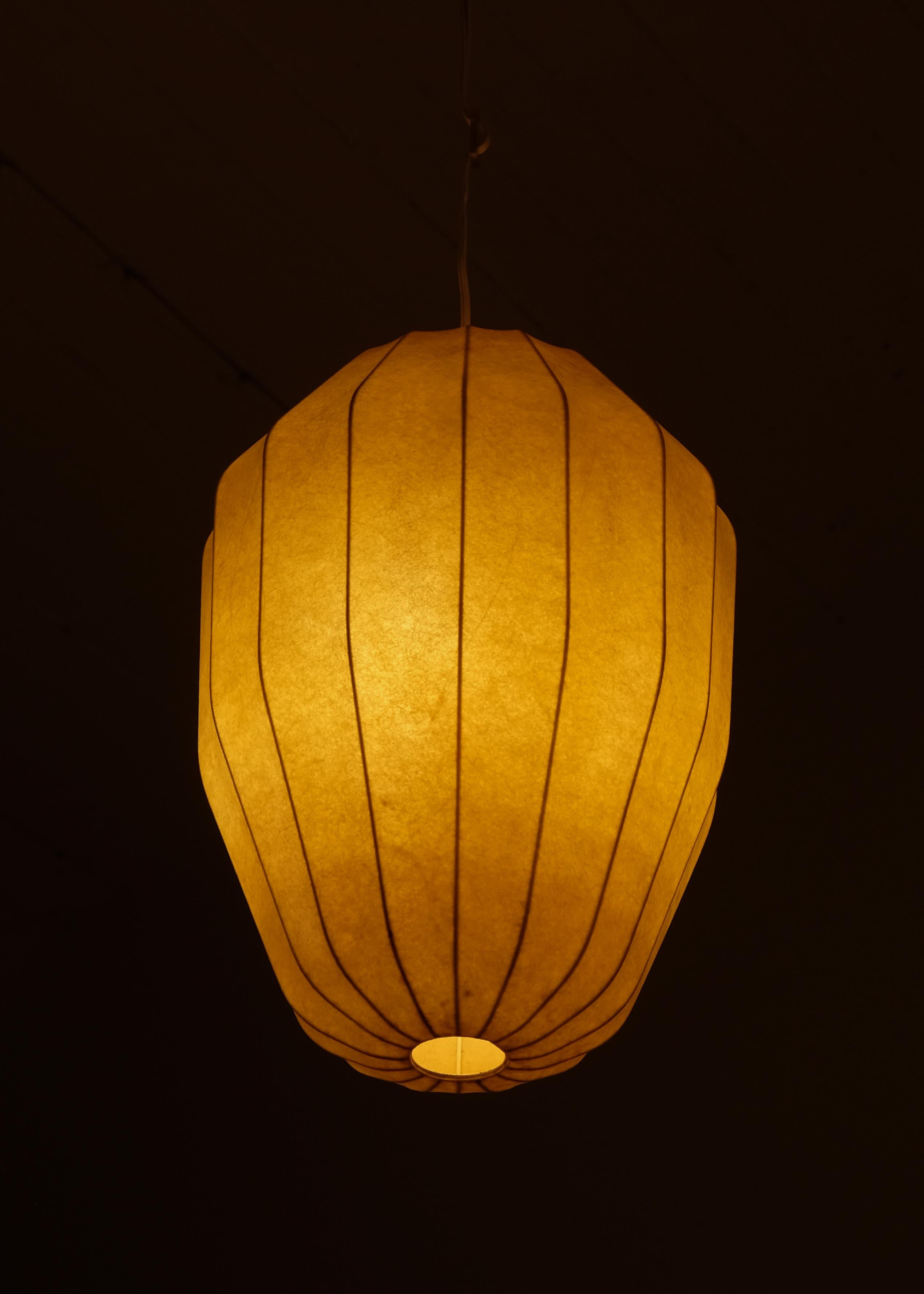 A stunning Swedish Modern pendant lamp, likely designed by Hans Bergström and possibly produced by Ateljé Lyktan. 
This elegant piece features a cage-like metal frame and a plastic-sprayed shade, creating a soft and diffused light. The lamp