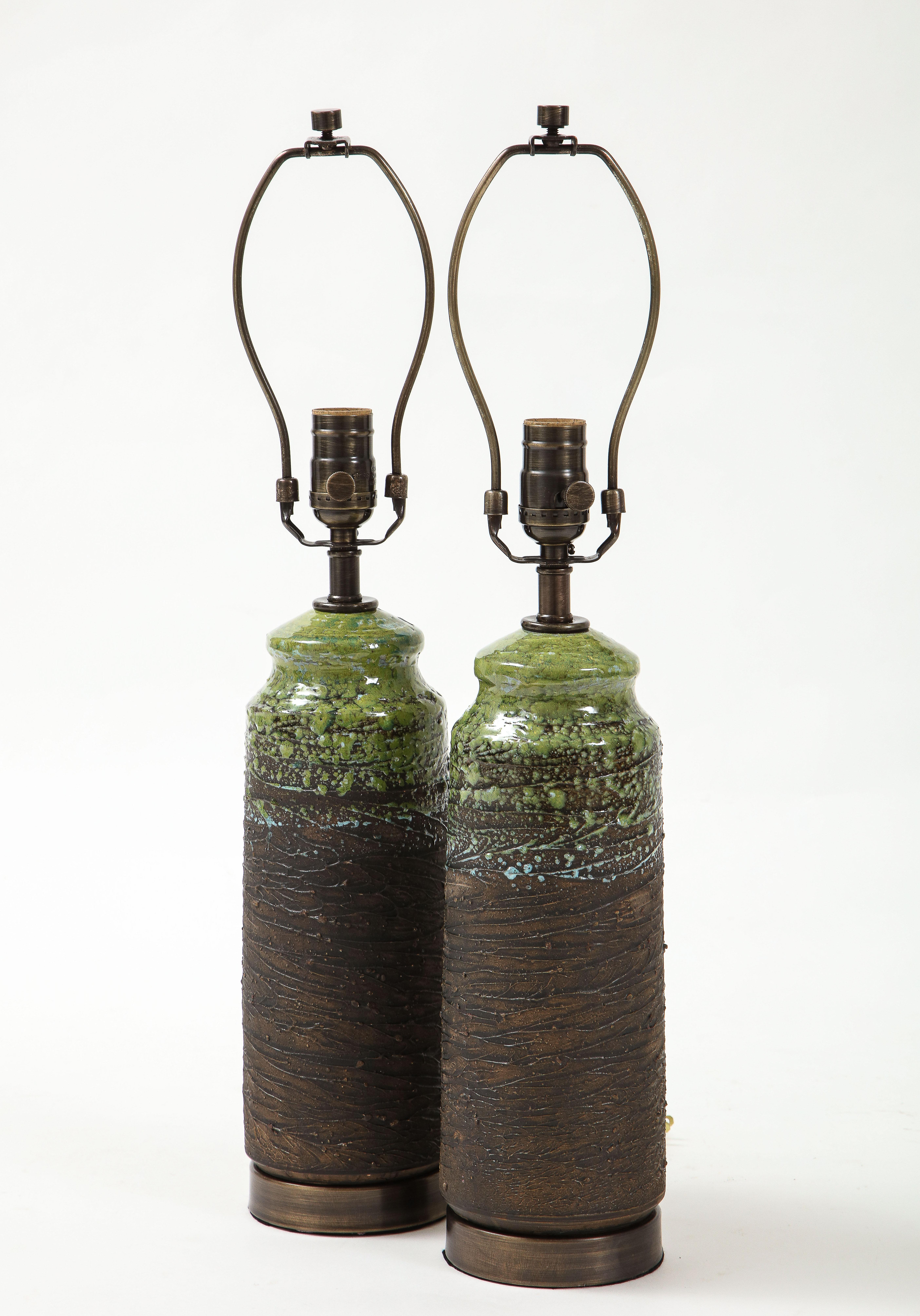 Pair of Swedish modern ceramic lamps with bark brown glazed bodies contrasted by a moss green top and a hint of ice blue. Lamps sit on dark bronze bases and have bronze fittings. Rewired to USA standards, 100W max.