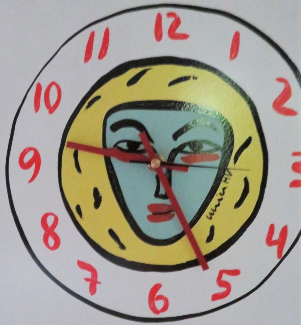 By Ulrica Hydman Vallien, ceramic wall clock retailed in the 90s by Time Design. Designed with Hydman' s iconic triangular face in turquoise surrounded by a yellow circle in a white background with clock hands, including seconds, and numbers in red.