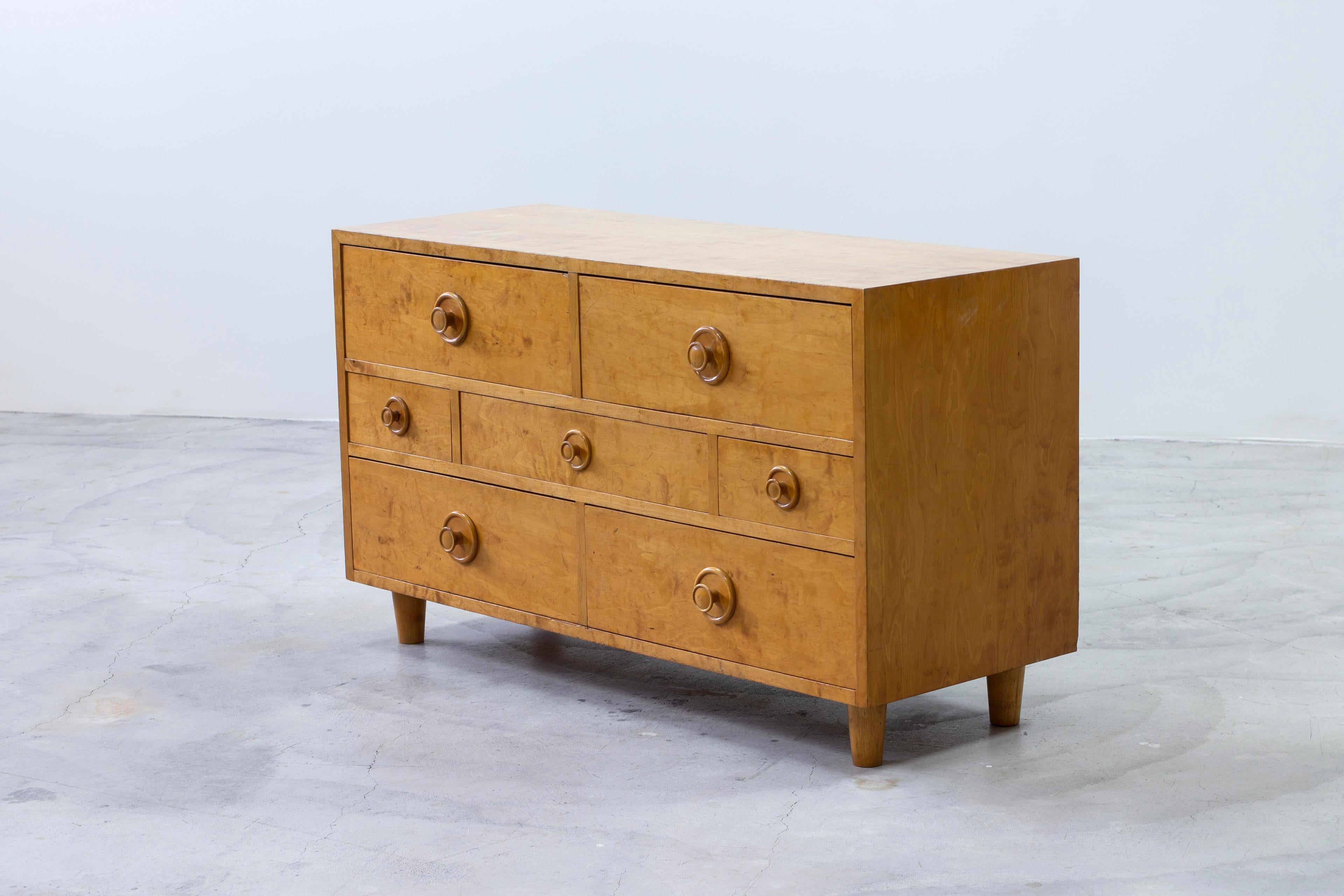 Exceptional Swedish modern chest of drawers. Made from birch with lovely honey tone. Made by unknown designer and Swedish cabinetmaker during the 1930-40s. Seven drawers with oversized round handles. Good vintage condition with some age related wear