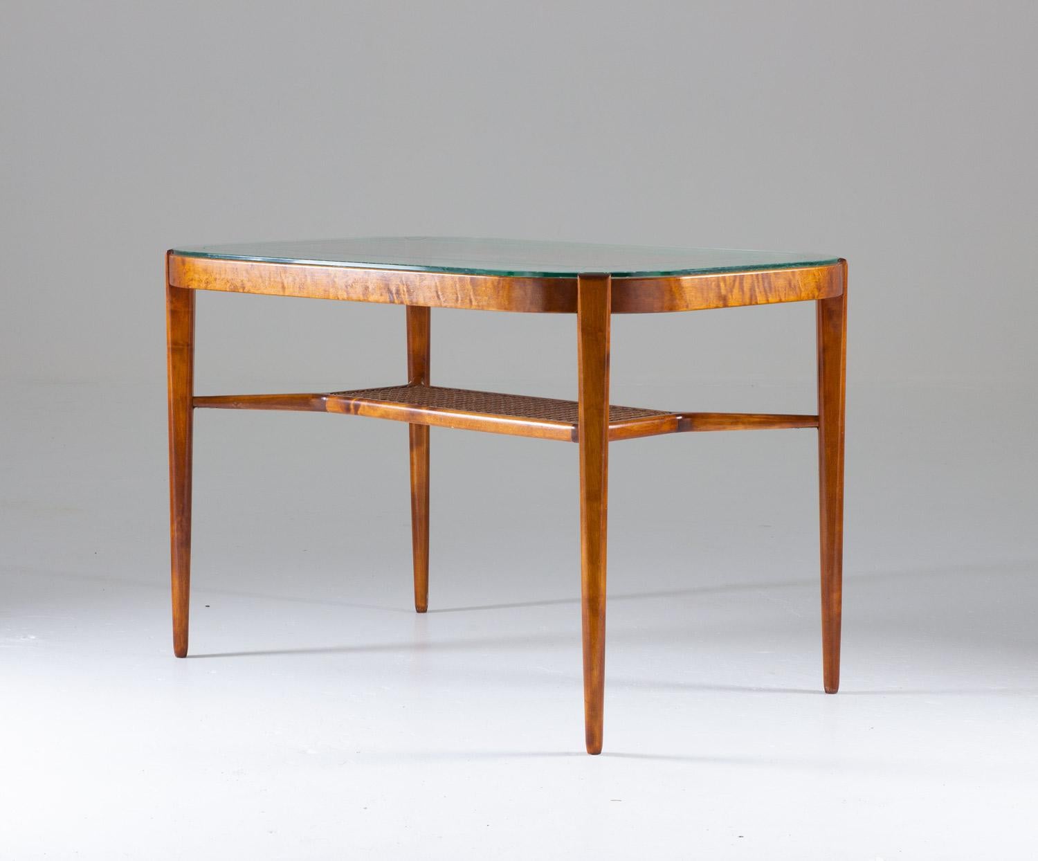 Beautiful coffee or side table made of birch, rattan and glass by Bodafors, Sweden.
The table consists of the original glass tabletop with etched ornaments, supported by a birch frame with a rattan magazine shelf.
Condition: Very good original