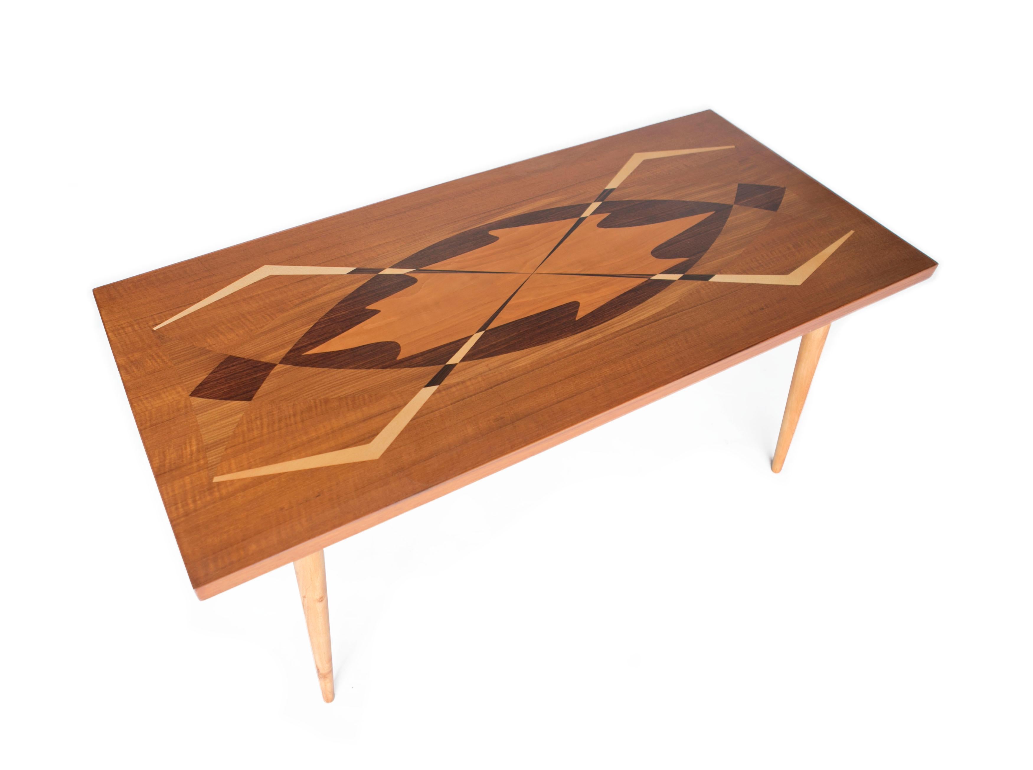 Swedish modern coffee table with exotic wood inlay, Sweden, 1950s

This is a very special Swedish coffee table with exotic inlaid wood in very midcentury graphical patterns. Maker is unknown but likely made in Tranås Sweden who were well known for