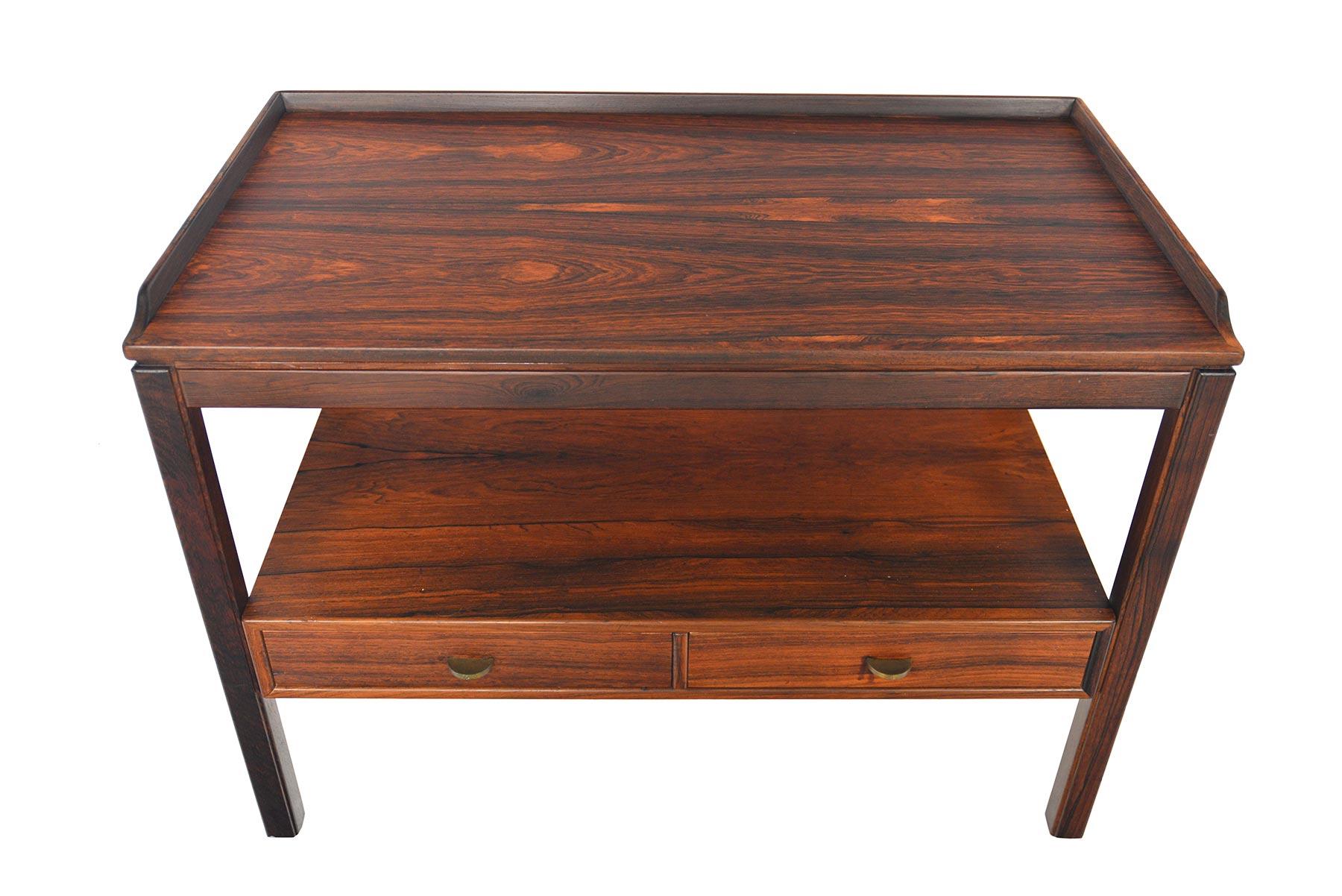 This stunning Swedish modern console table in Brazilian rosewood was designed by Sven Engström & Gunnar Myrstrand for Tingströms, Bra Bohag in the 1960s. Table features a raised lip and two lower drawers for additional storage. In excellent original