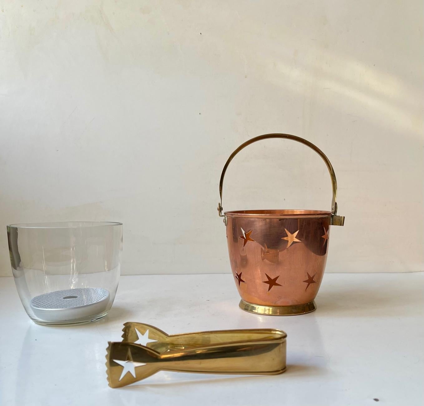 Ice bucket set consisting of ice bucket, glass insert, water filter and tong. The bucket and tong is made from solid copper and brass. The brass tong attaches to the side of the bucket. Designed and made by Mitab Karlshamn in Sweden during the 1950s