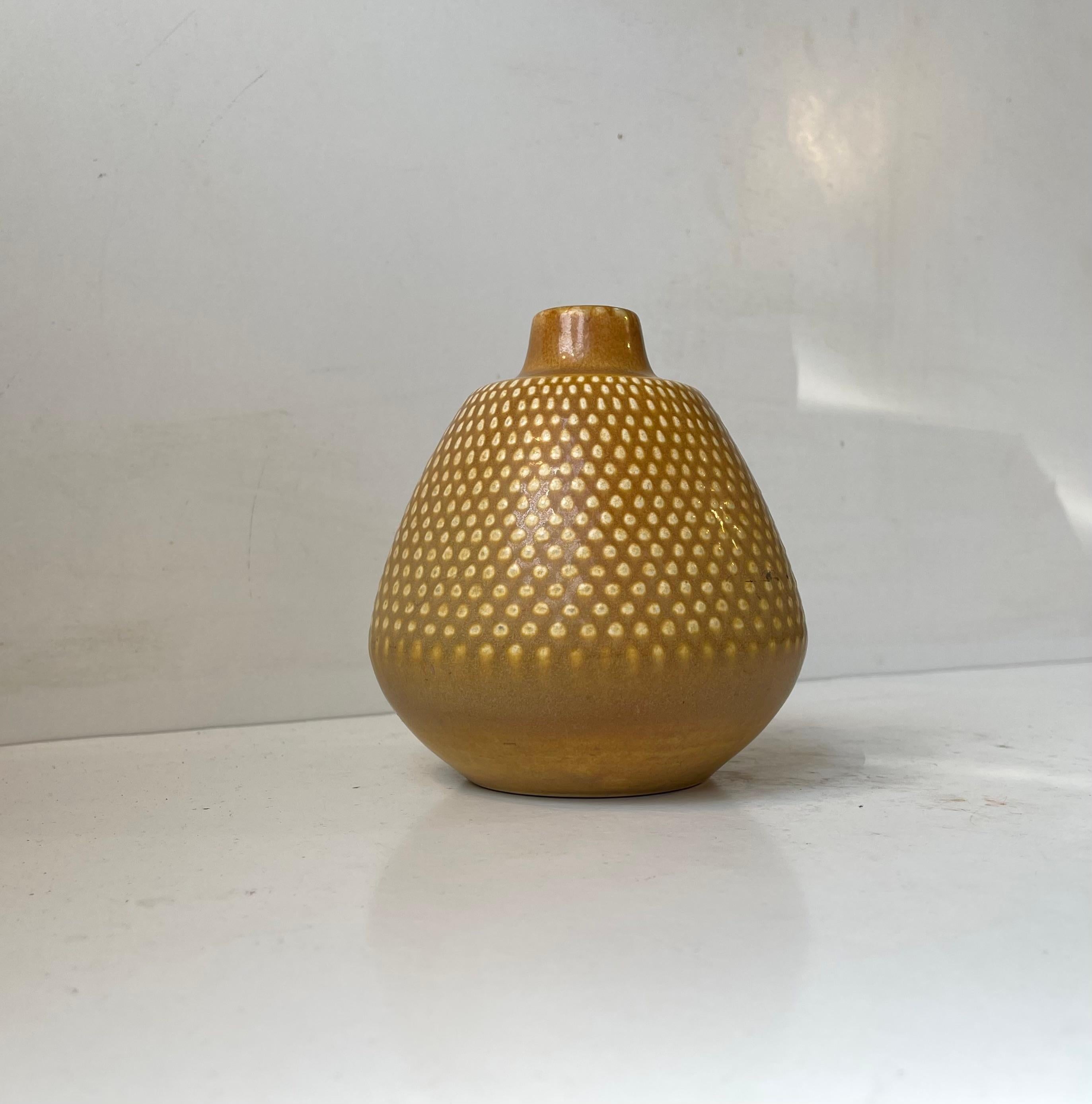 Exceptional unidentified Swedish ceramic vase with pertruding dots and delicate ocra yellow haresfur glaze. Very similar to pieces by Gunnar Nylund, Carl H. Stahlhane, Nils Thorsson and Saxbo. Very indistinguishable marked. Measurements: H: 14.5 cm,