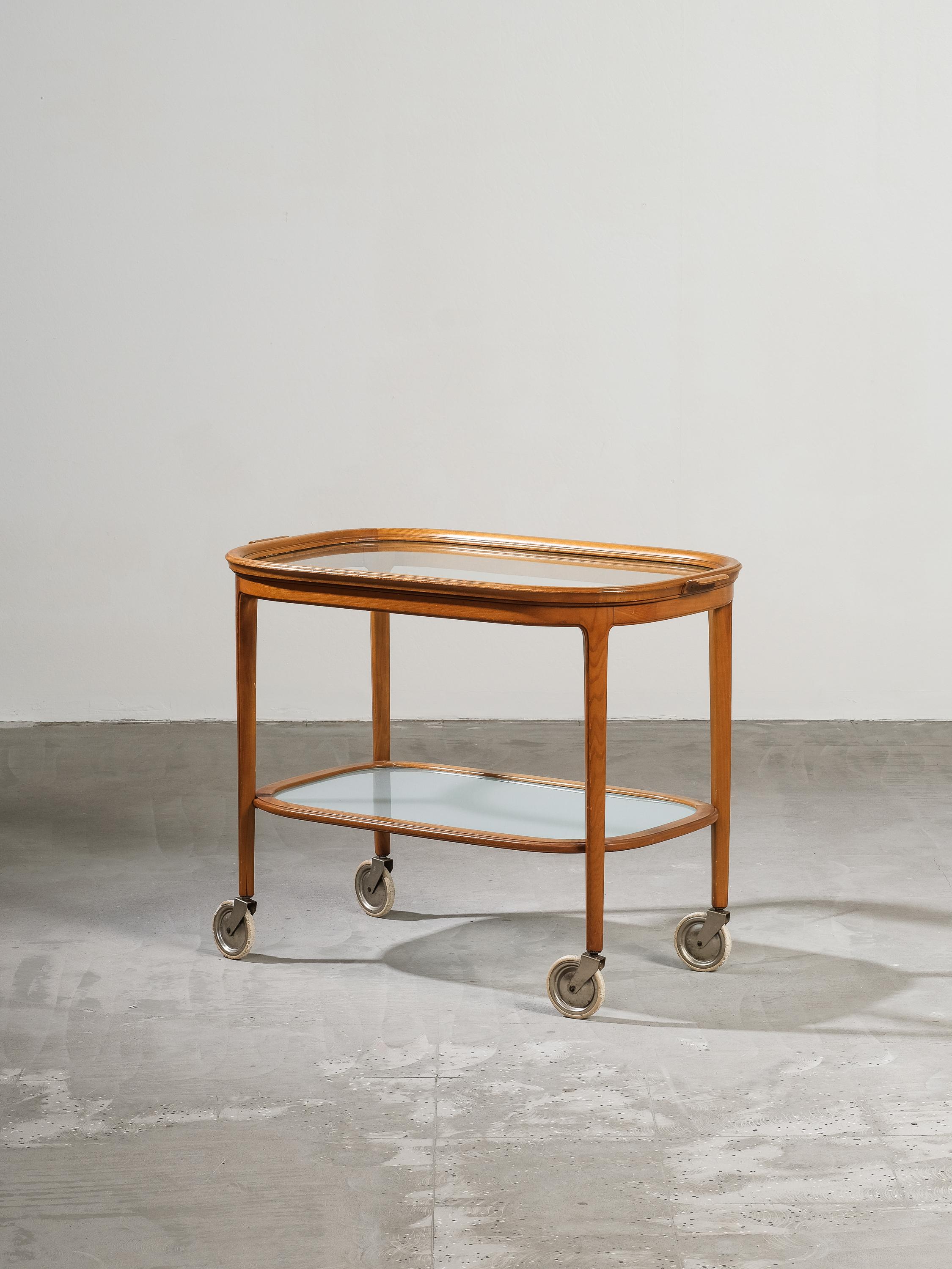 Lovely Swedish serving cart or side table from 1940s. Made from elm with beautiful curved lines. Table top/tray with clear glass and shelf with matte glass.