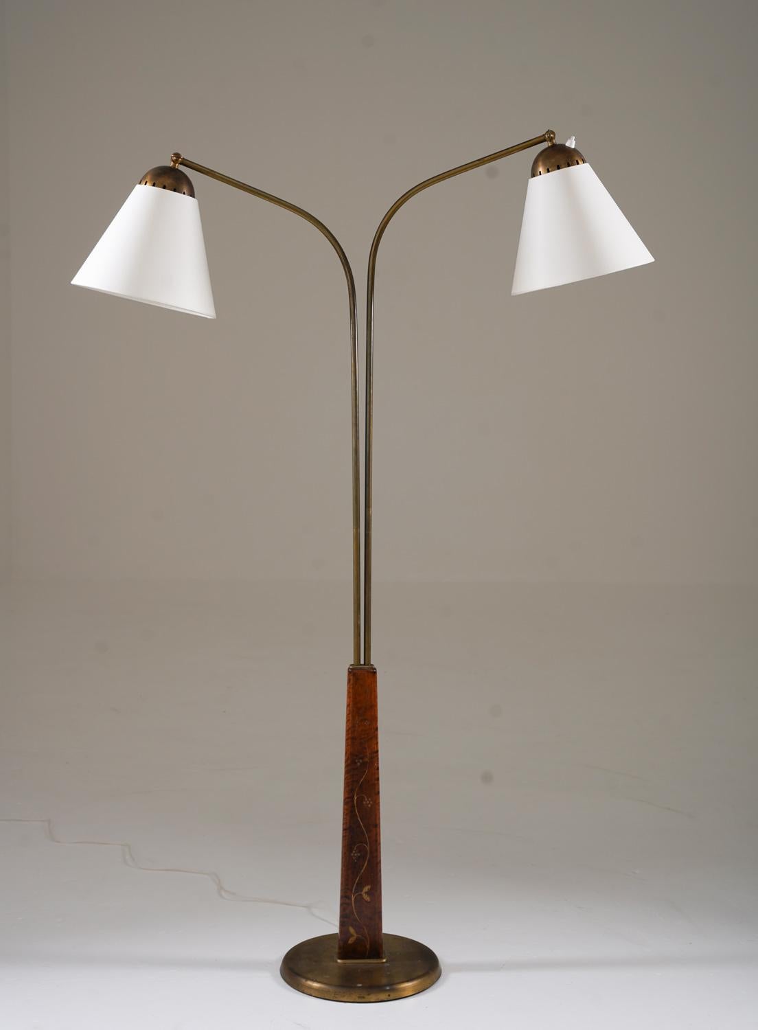 A beautifully crafted Swedish Modern floor lamp, designed by Tor Wolfenstein for Ditzingers in the 1940s. This elegant piece features a tapered birch base, adorned with delicate gold-painted floral motifs, adding a refined decorative touch. The