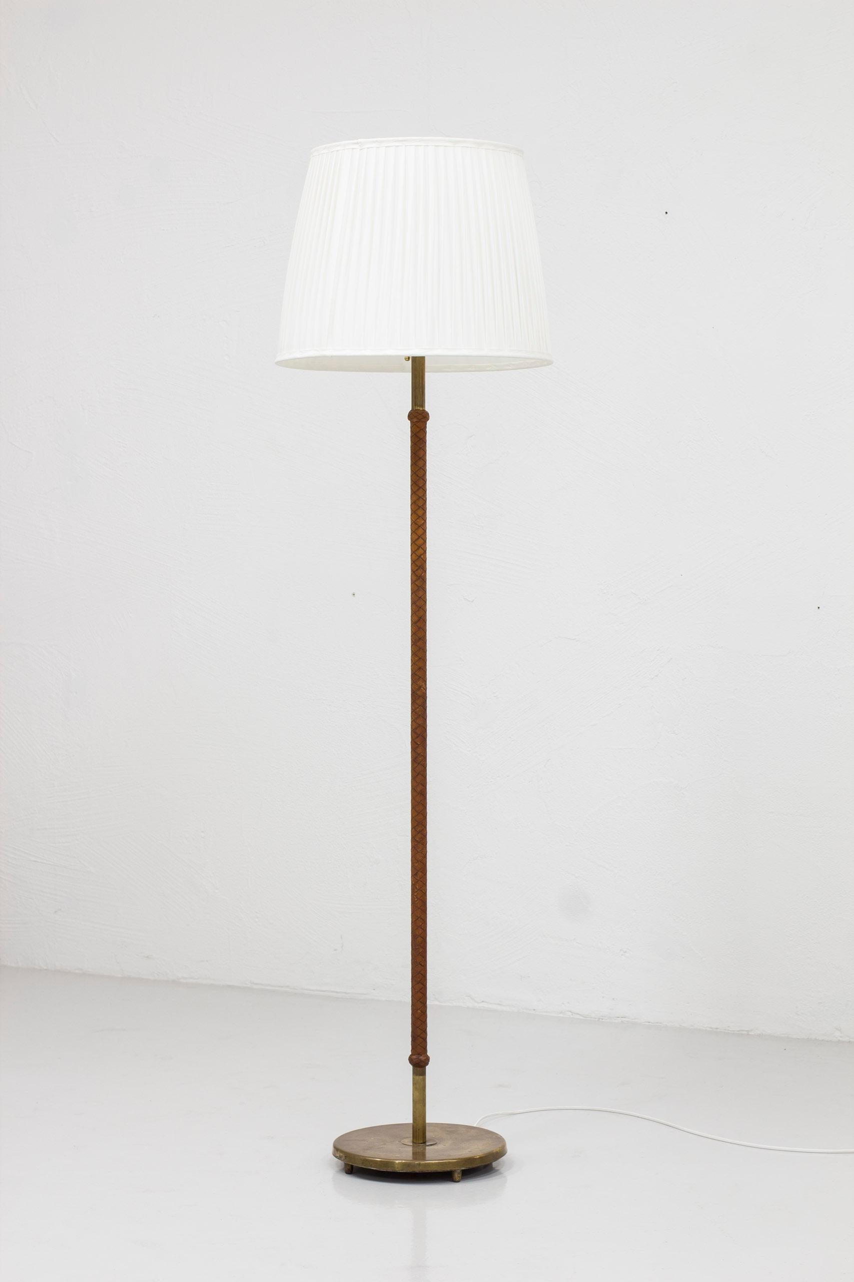 Scandinavian Modern Swedish modern floor lamp with original braided cognac leather and brass, 1940s