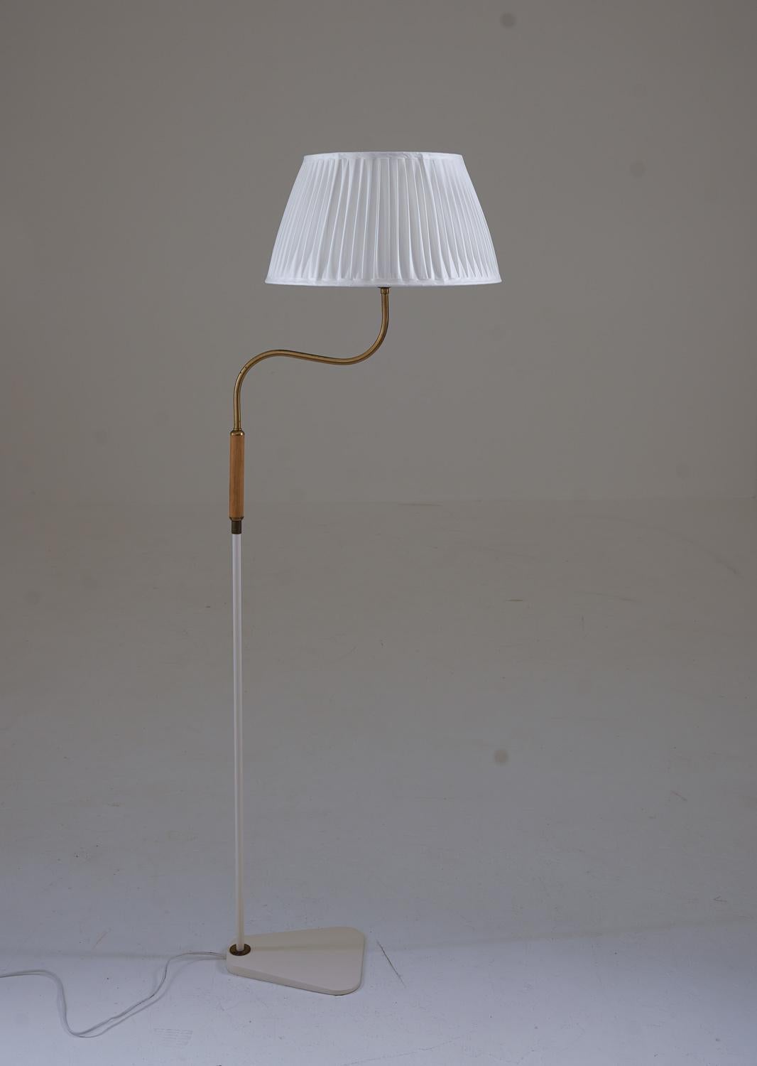 Swedish modern floor lamp attributed to ASEA.
The lamp is made of lacquered metal, with details brass and teak details.

Condition: The lamp has been re-lacquered and comes with a new hand-pleated shade.