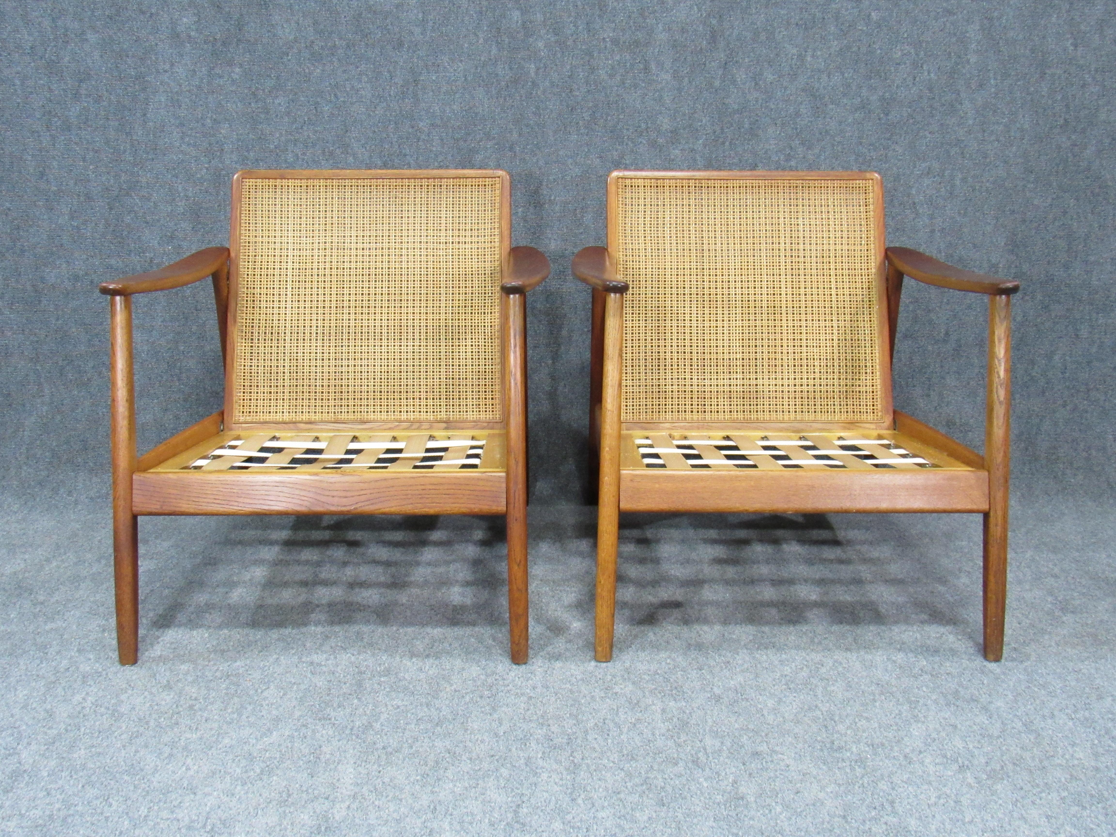 Swedish modern Folke Ohlsson lounge teak arm chair with cane backrest for Dux. Made in Sweden in the 1950s. Does not come with cushions. Seat height listed without cushions.