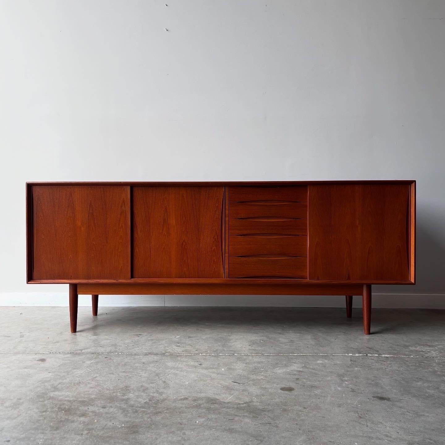 This exquisite mid-century credenza represents the pinnacle of Scandinavian craftsmanship from the golden age of Nordic design. Created by accomplished furniture maker Fredrik Kayser around 1960, this piece embodies the clean aesthetic principles
