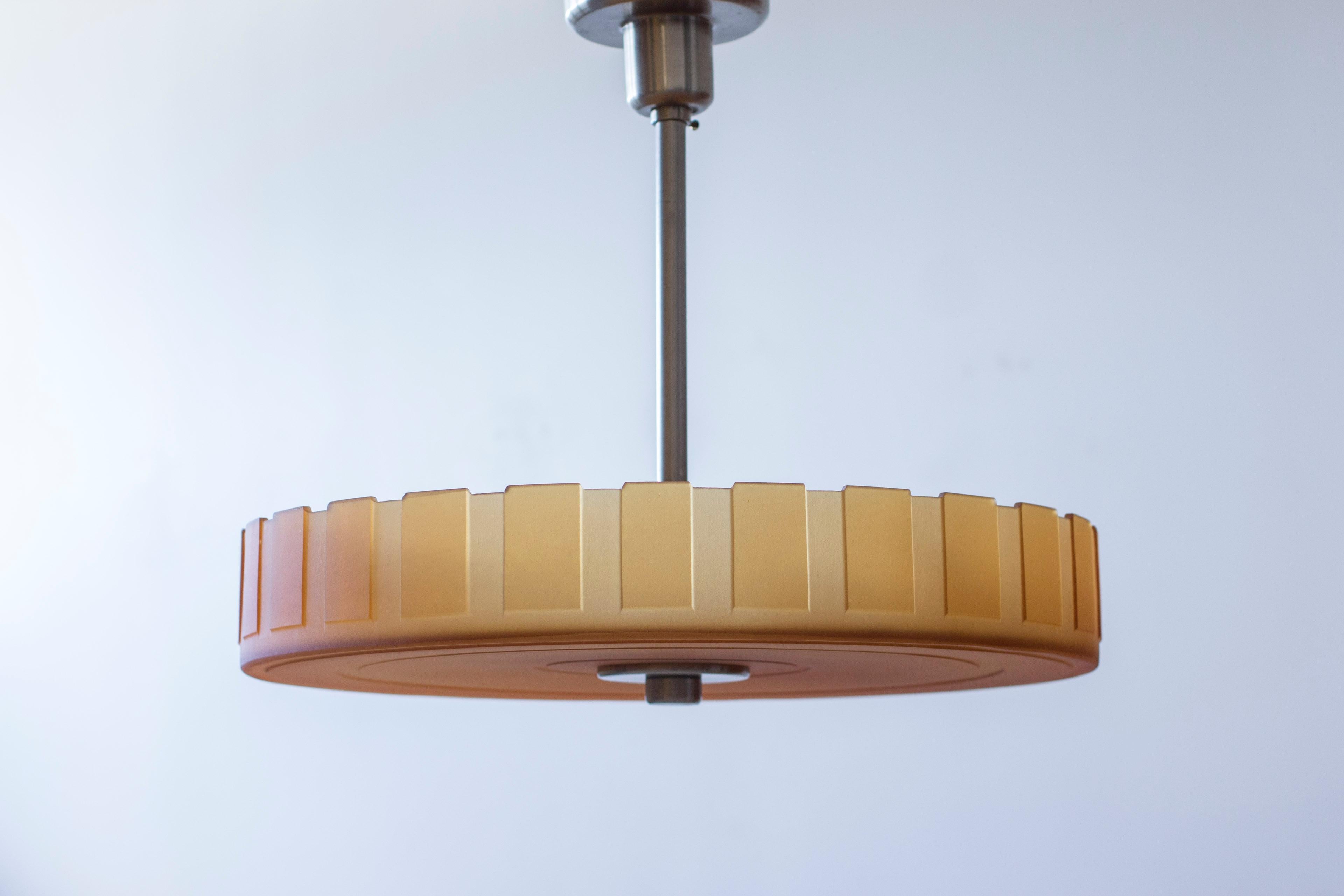 Colgante de techo semienrasado moderno sueco de latón niquelado y cristal grabado de color ámbar con motivos geométricos. Muy alta calidad de la artesanía en metal, así como del cristal grueso y pesado con motivos geométricos tallados.  Precioso y