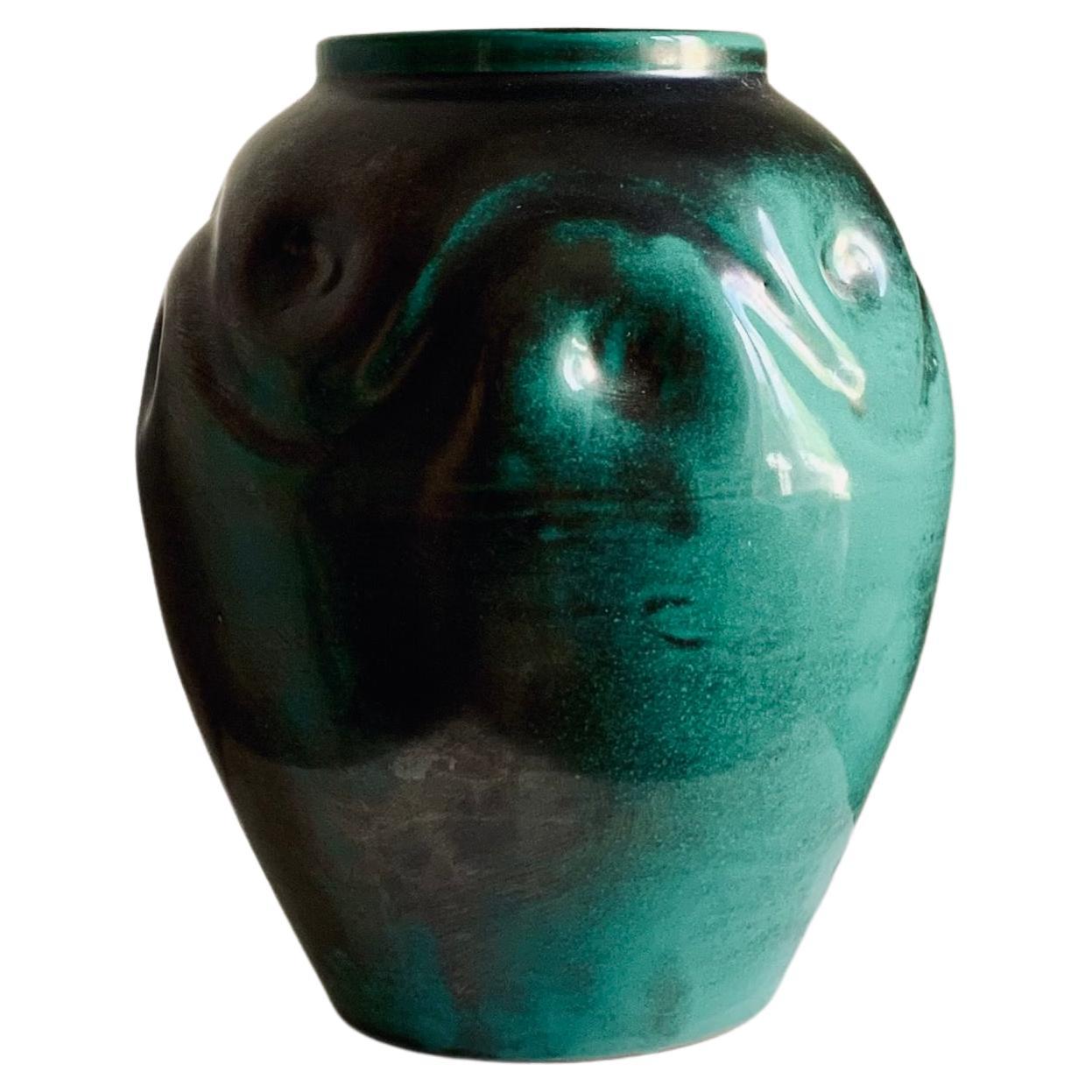 Swedish Modern sculptural earthenware vase with soft organic curves and green copper oxide glaze. Marked Ekeby 1500 (made between 1922-1938). This model vase is likely designed by Harald Östergren (1888-1974), who was employed at AB Upsala Ekeby