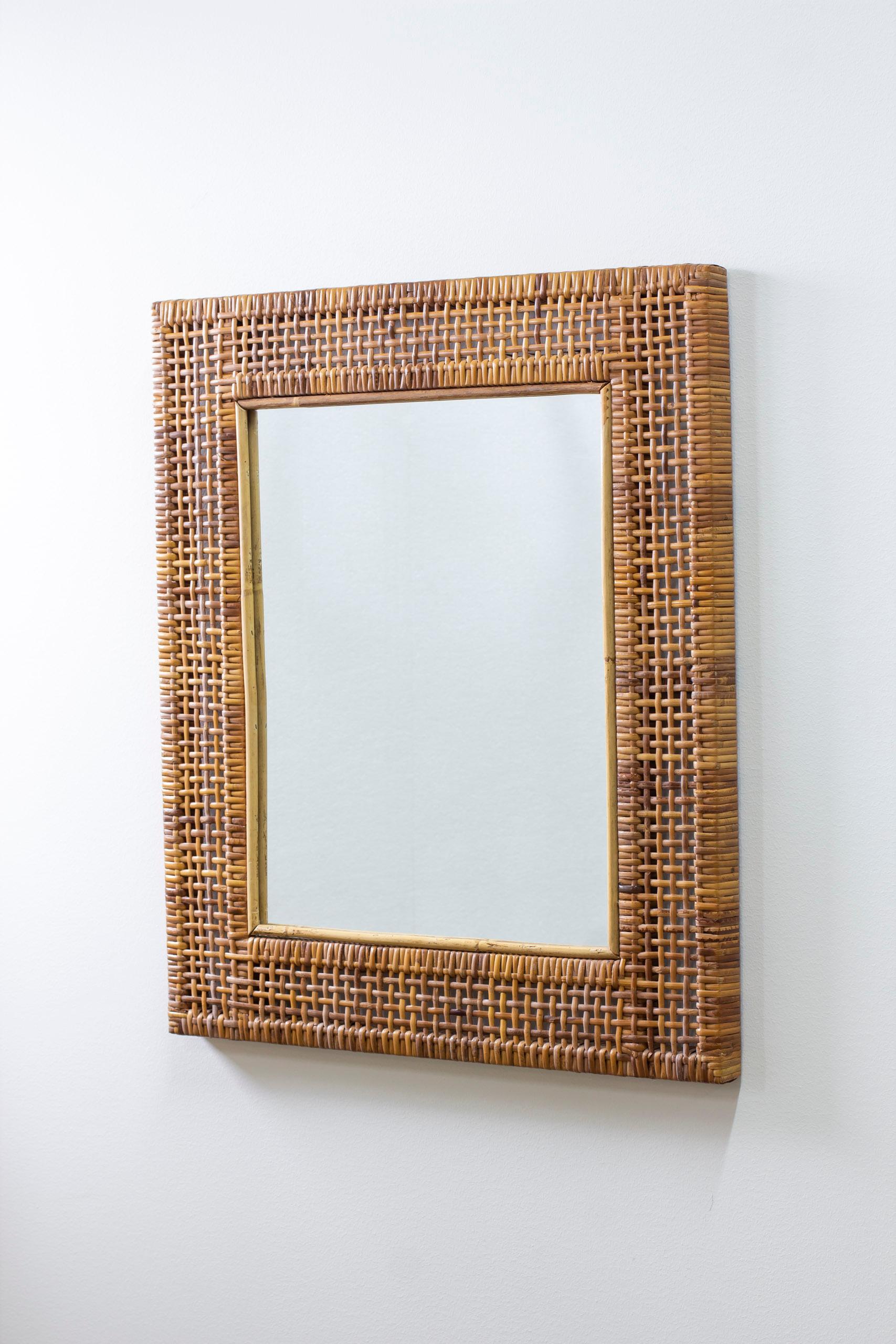 Wall mirror with hand woven cane frame. Woven on a solid teak frame. beautiful crafts and great quality piece. Done sometime during the 1950s. Very good vintage condition with light age related wear and patina to the rattan.



Designer: